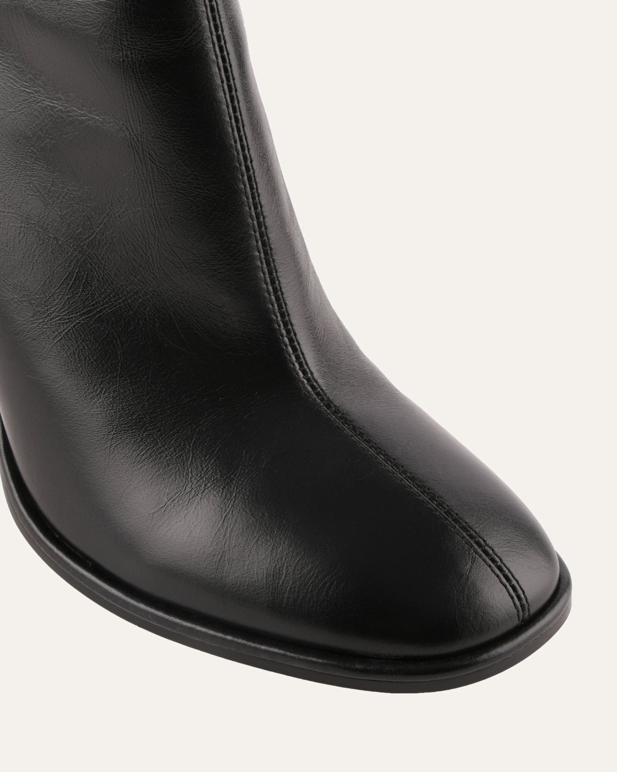 Black leather boot on a white background