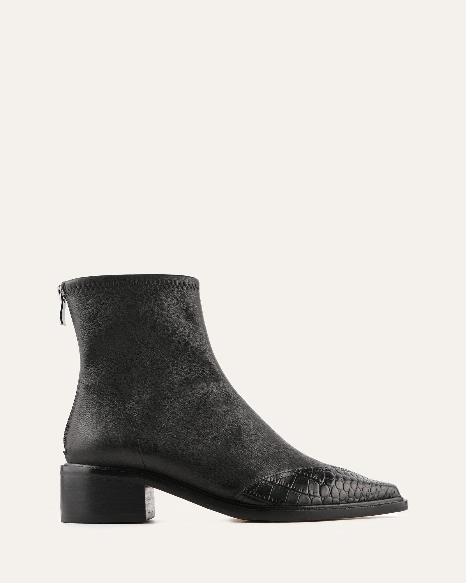 Black leather ankle boot with a crocodile texture on a white background