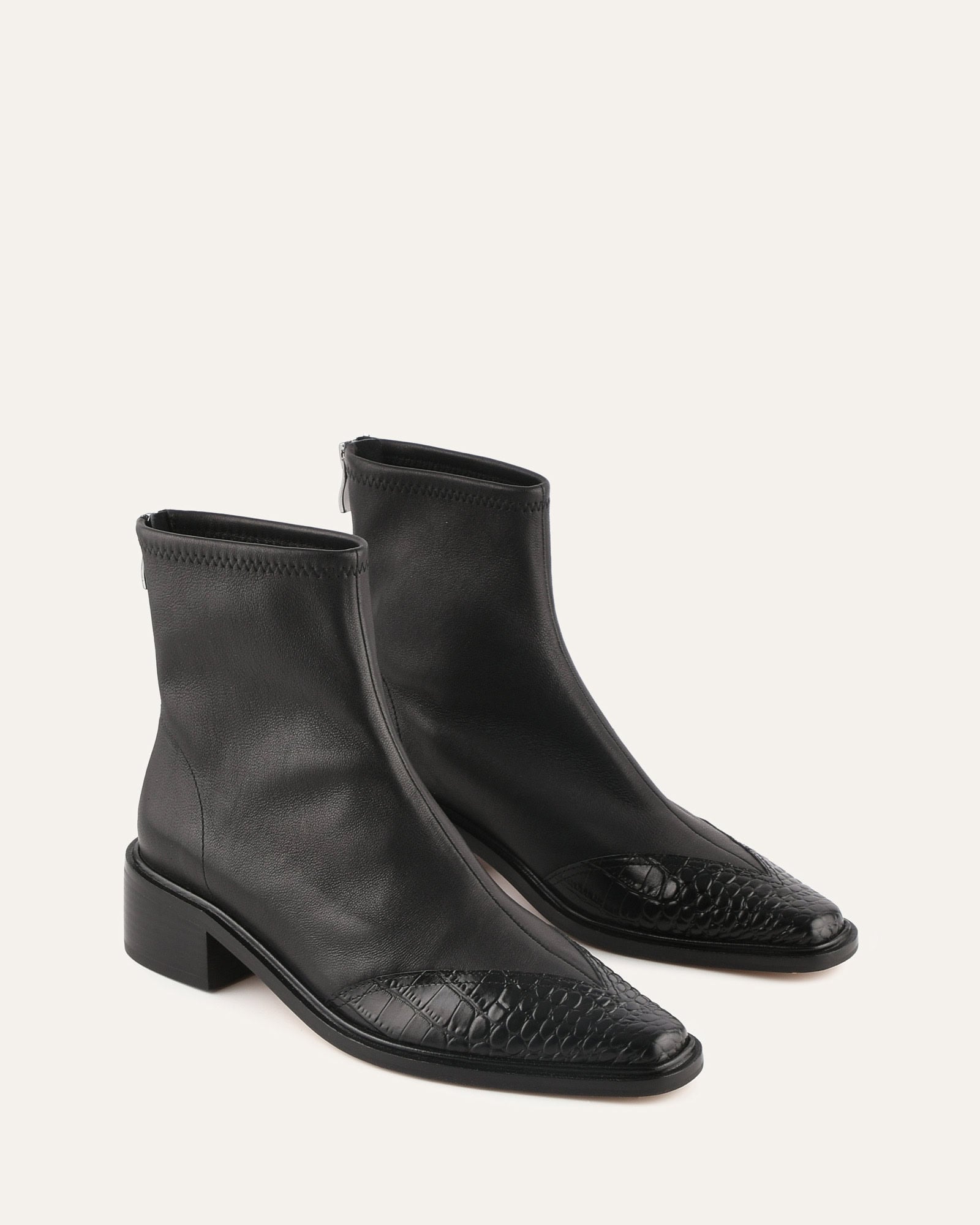 Black leather ankle boot with a crocodile texture on a white background