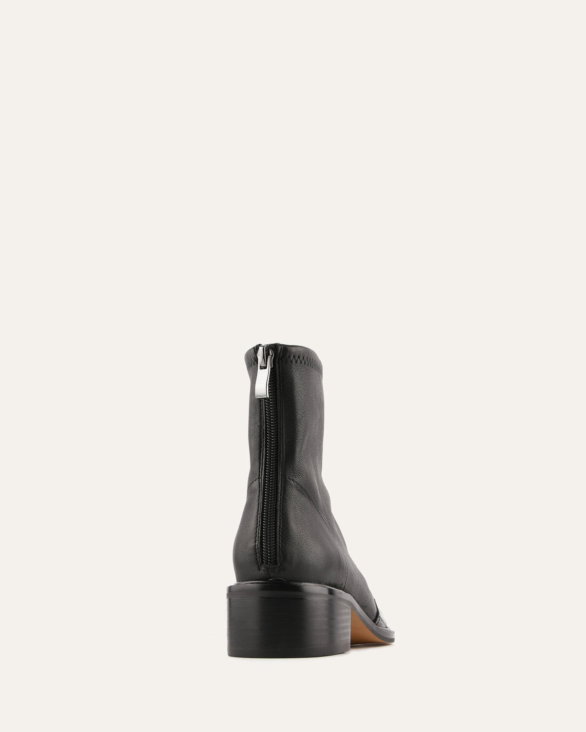 Black ankle boot with a zipper on a white background