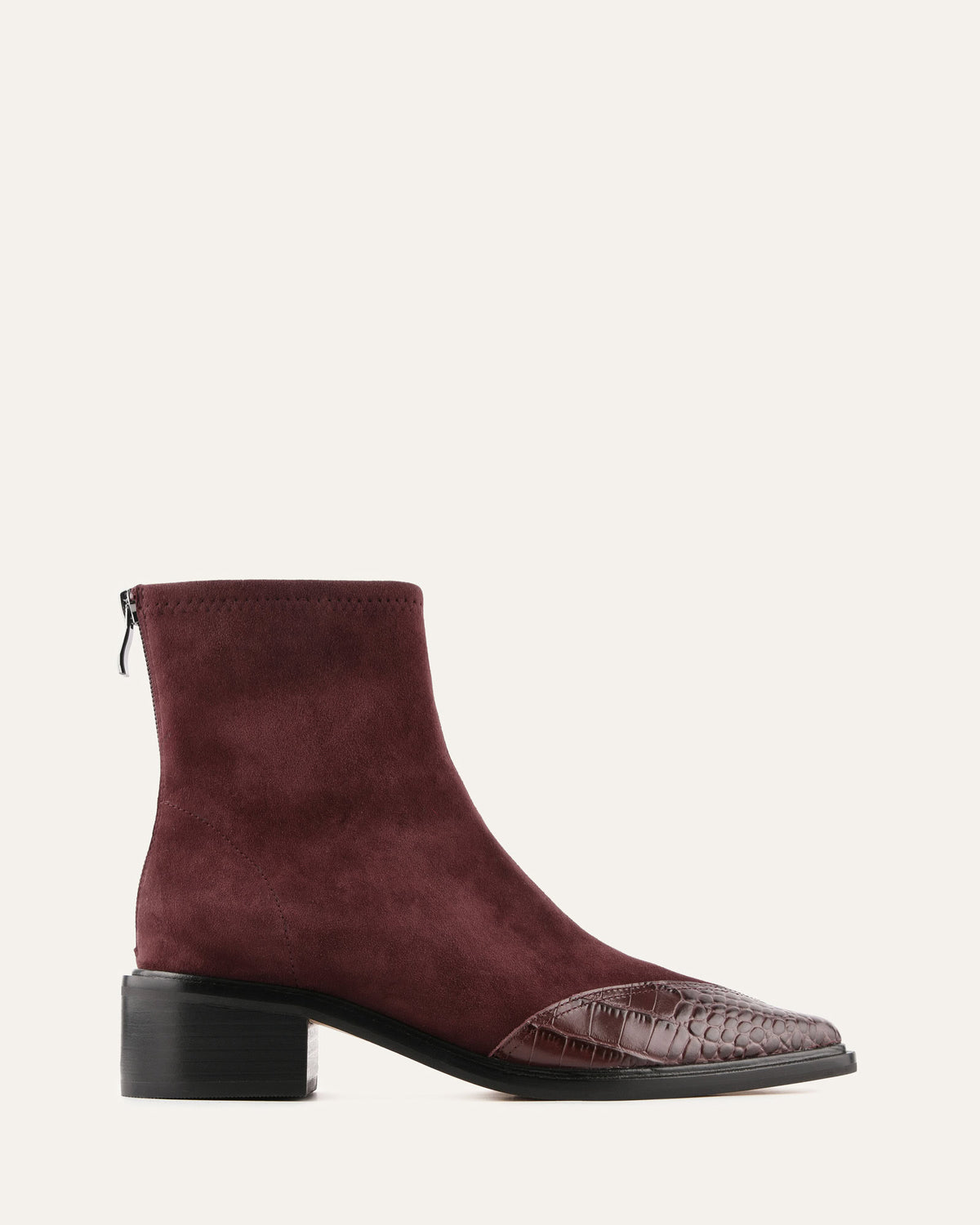 Maroon ankle boot with a crocodile pattern toe on a white background