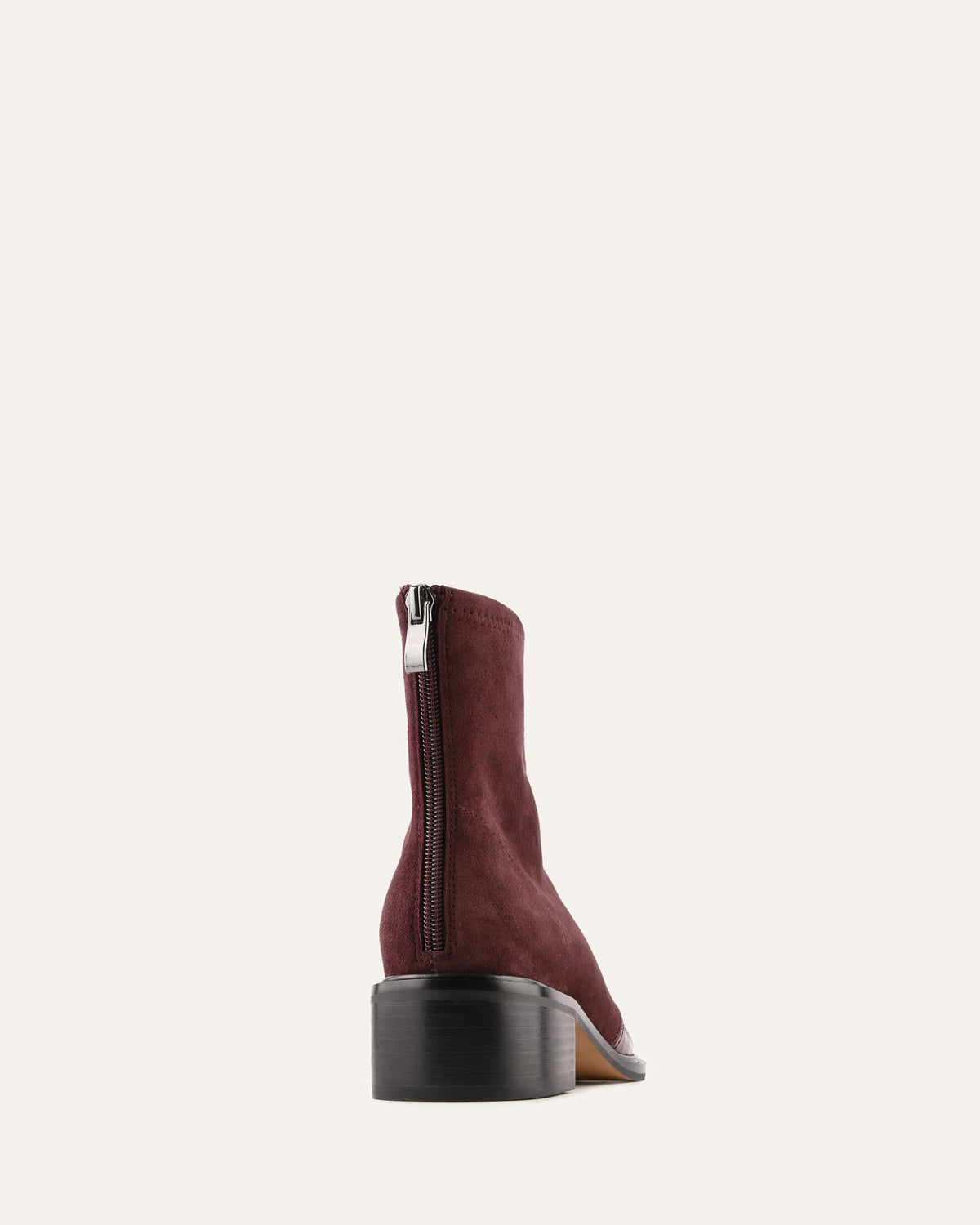 Maroon ankle boot with a zipper on a white background