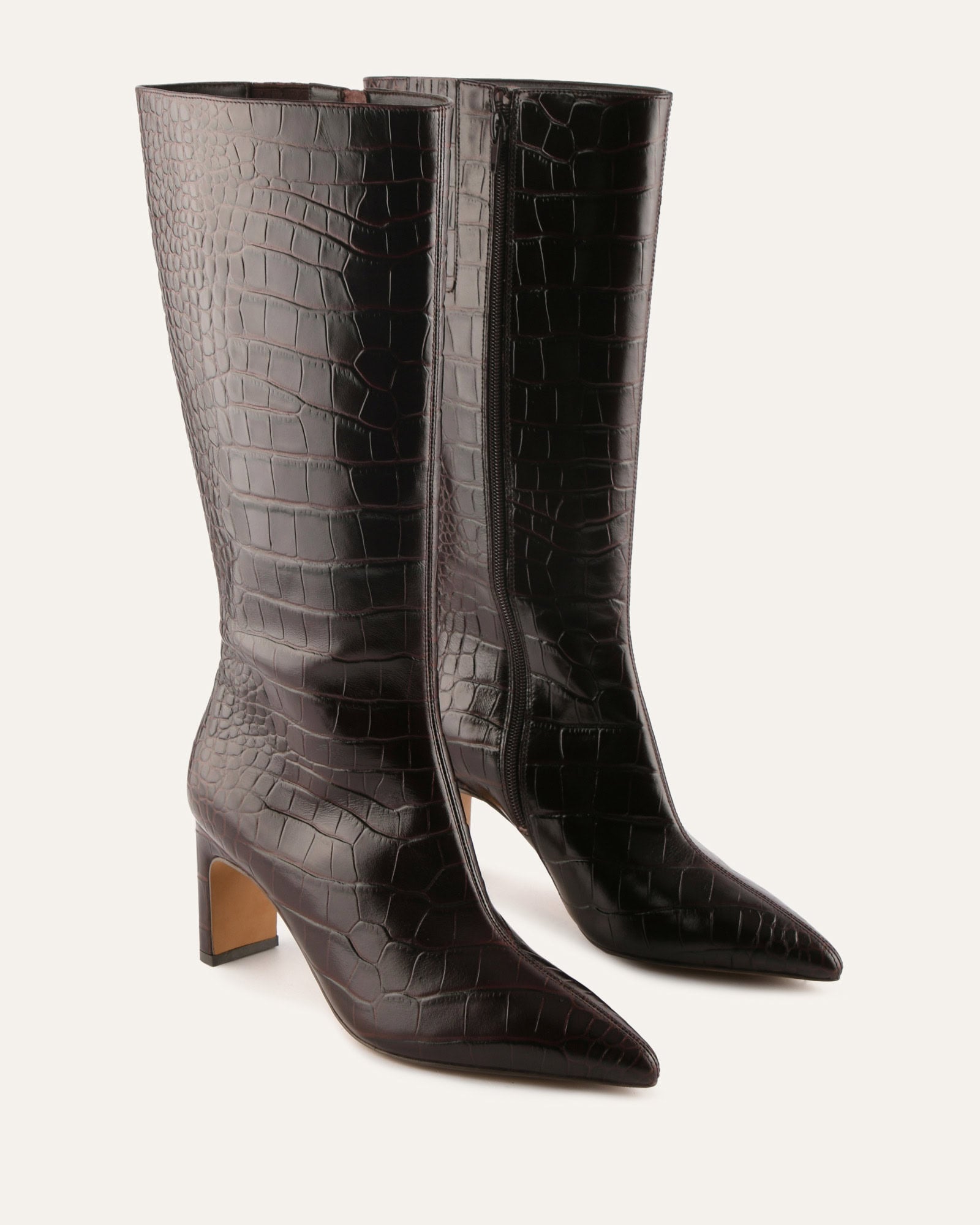 Browncrocodile-patterned knee-high boot on a light gray background