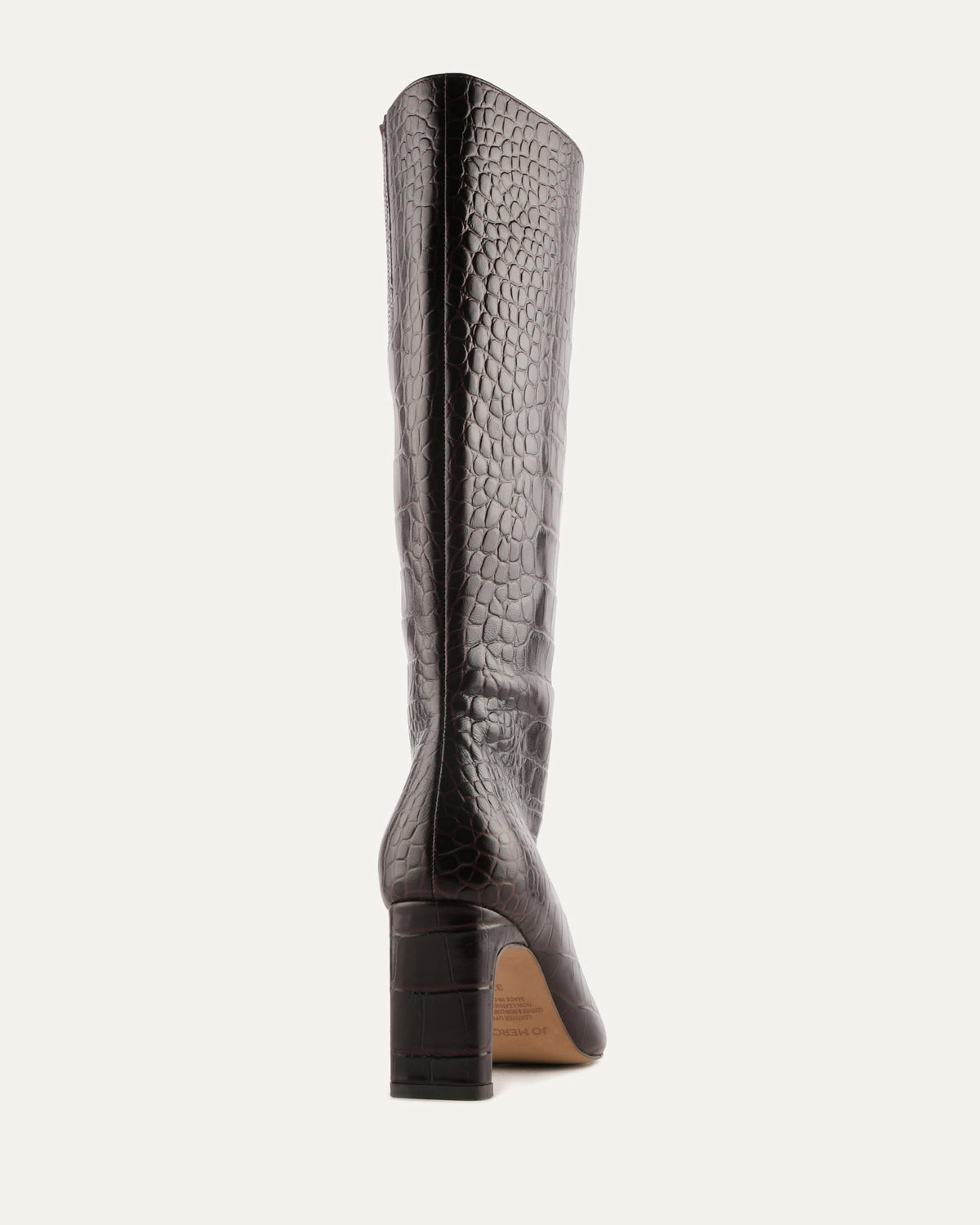 Brown knee-high boot with crocodile texture on a white background