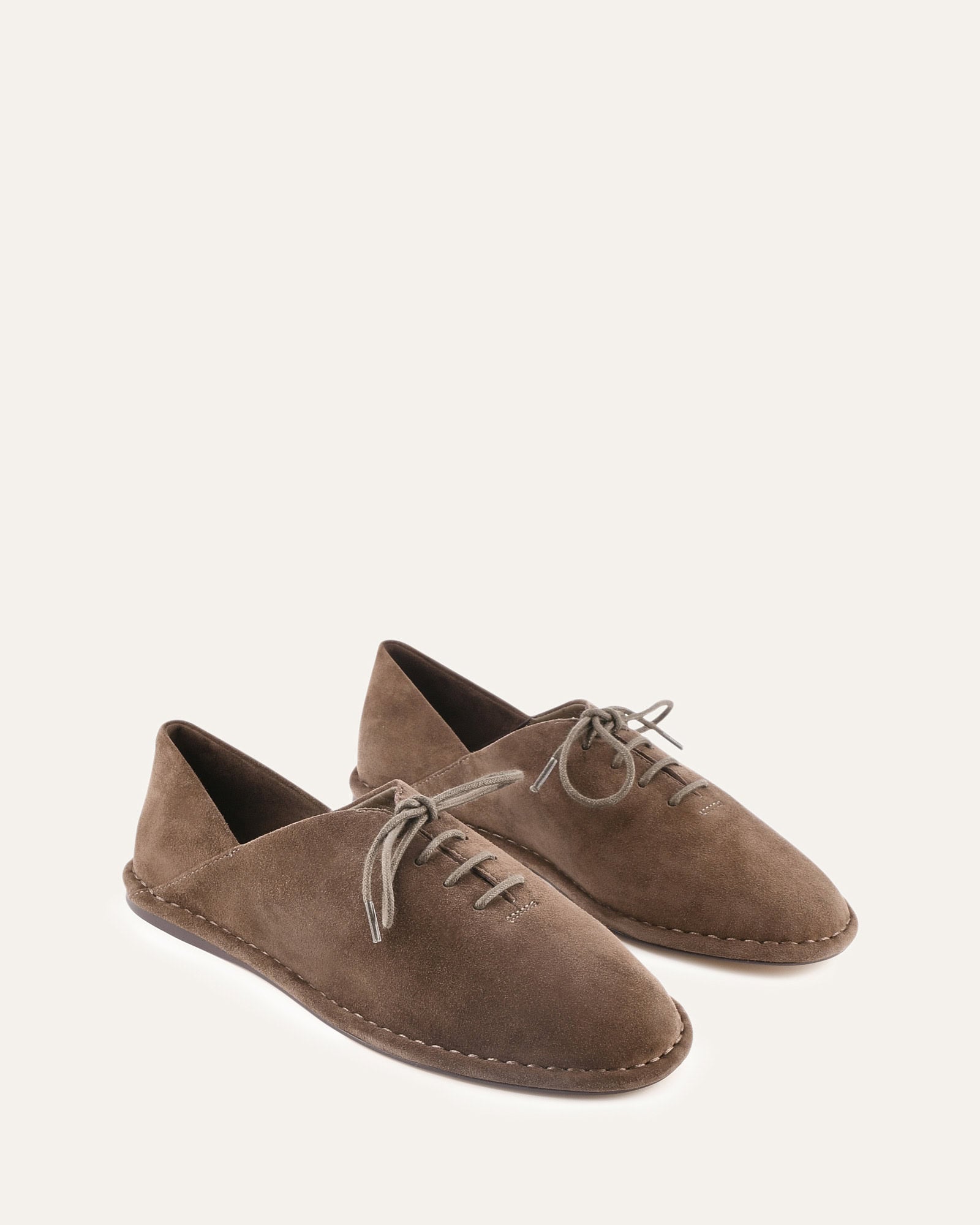 Brown loafer on grey background
