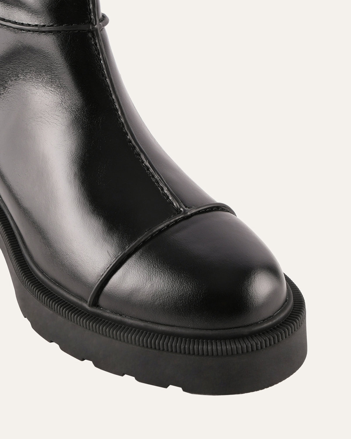 Black leather boot with a platform sole on a white background