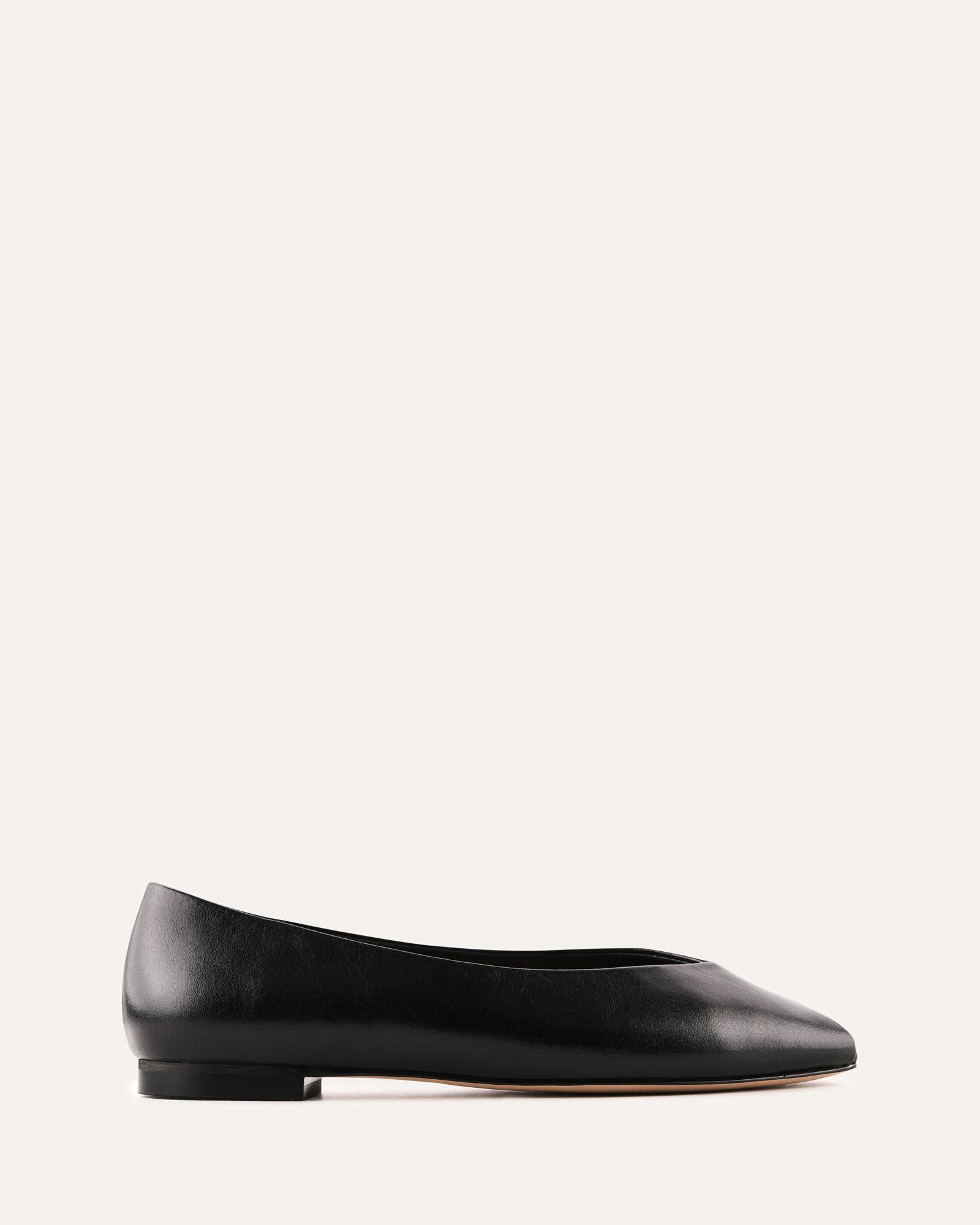 Black leather flat shoe on a white background