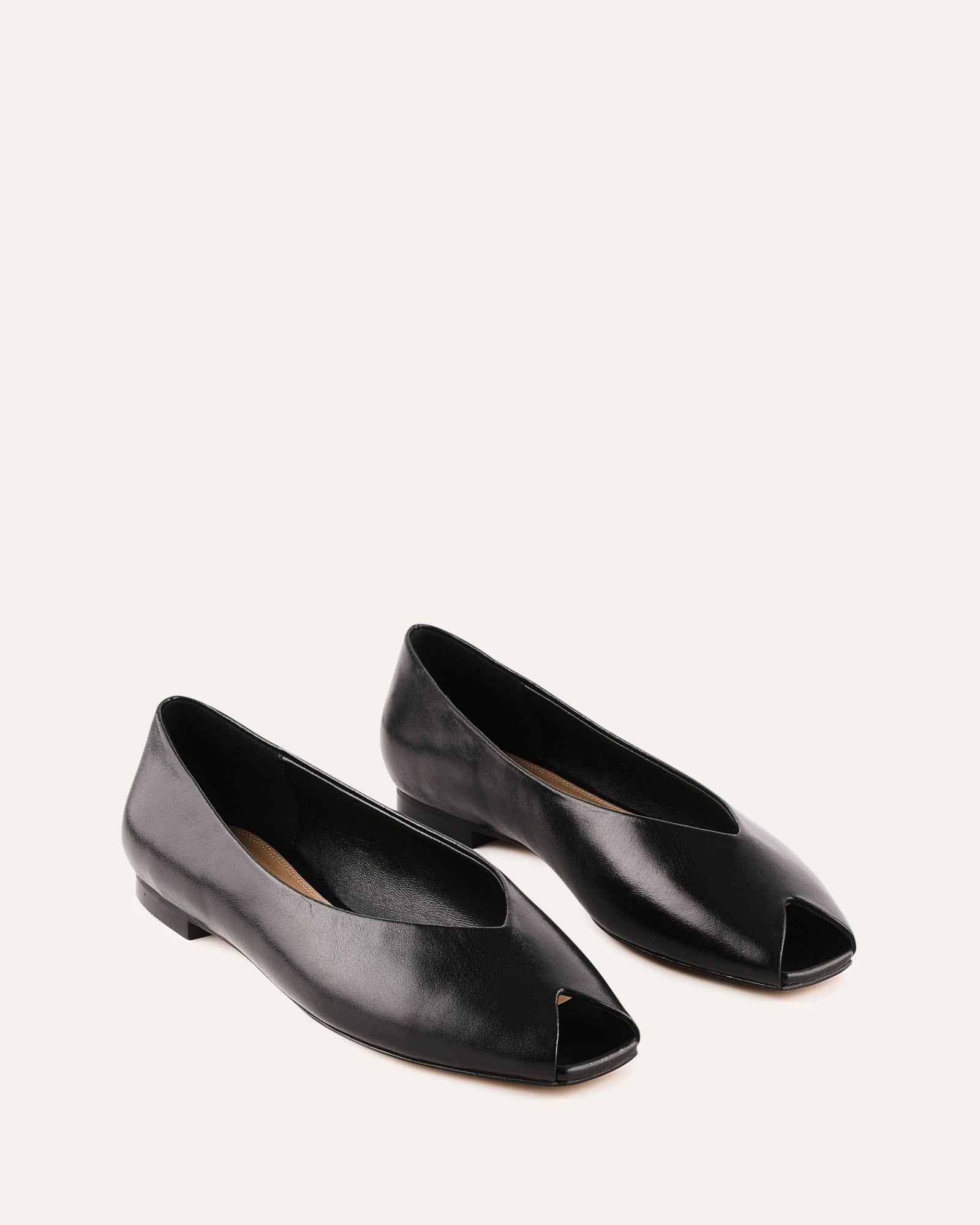 Black leather flat shoe on a white background