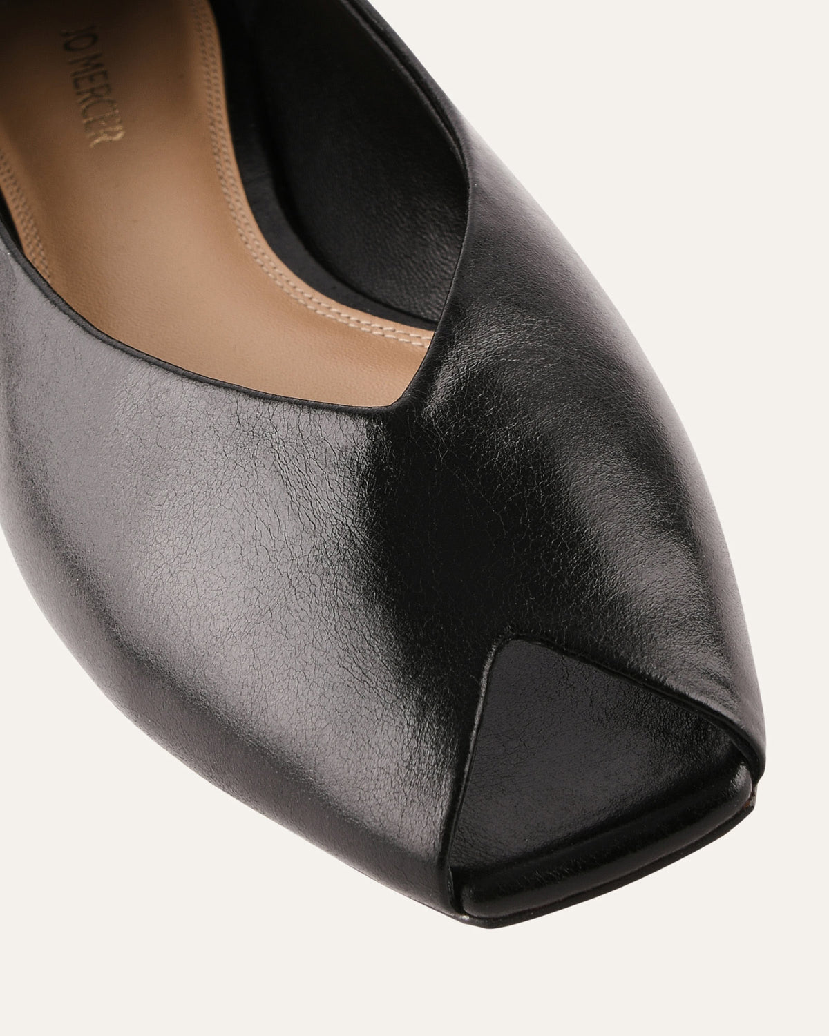 Black peep-toe shoe on a white background