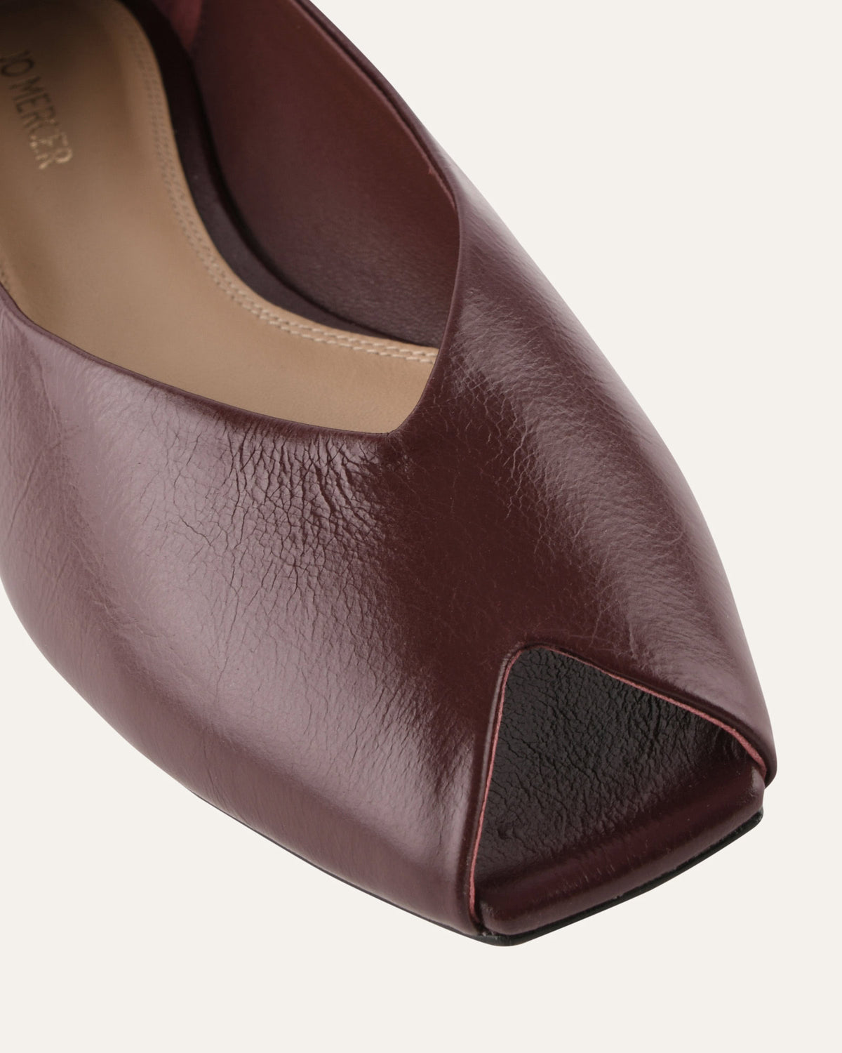 Brown peep-toe shoe on a white background