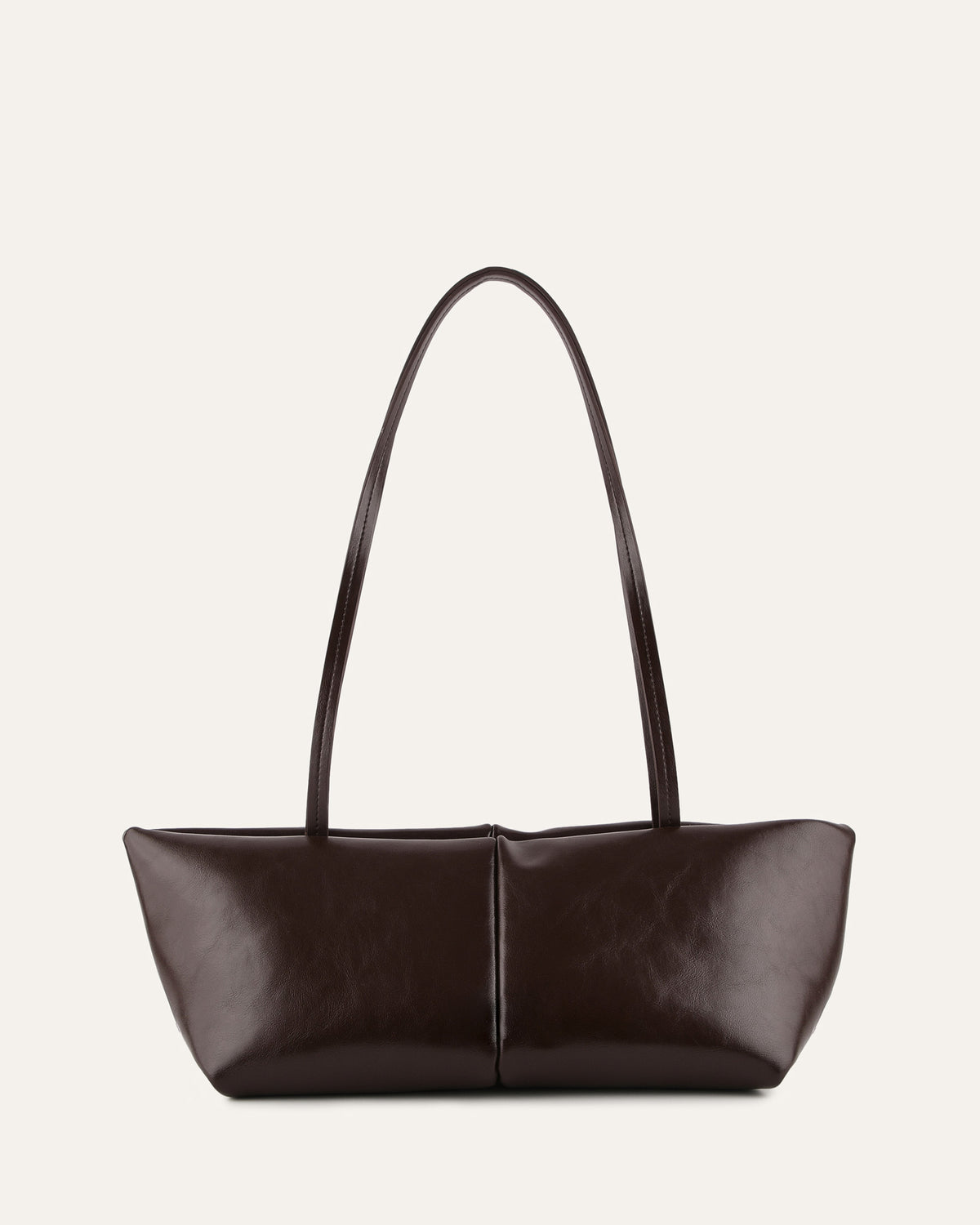 Brown leather handbag with a curved handle on a light gray background