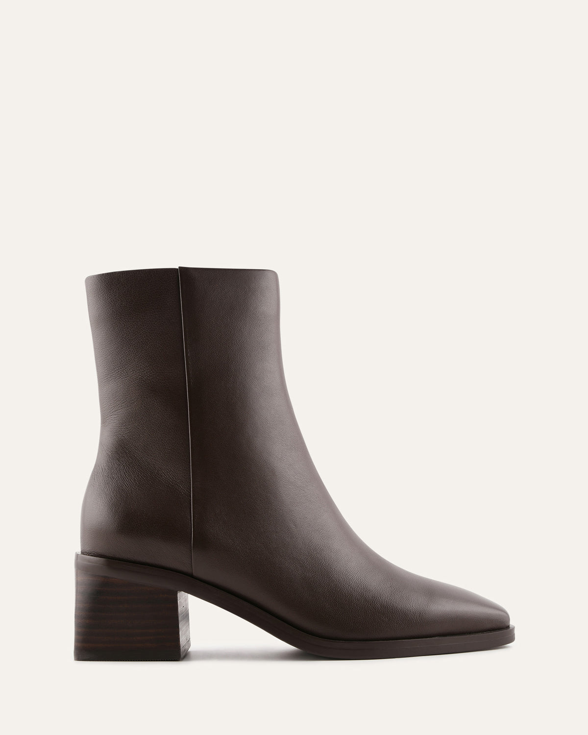 Dark brown ankle boot on a light beige background