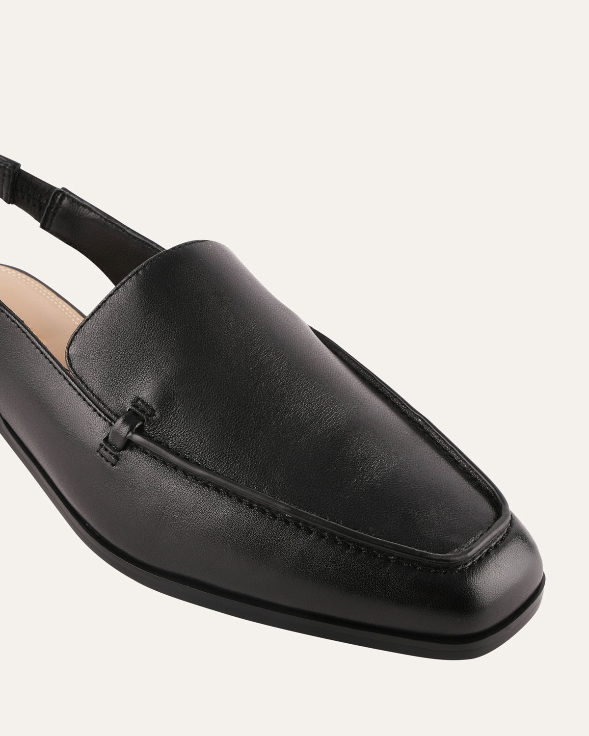 Black loafer shoe on a light gray background