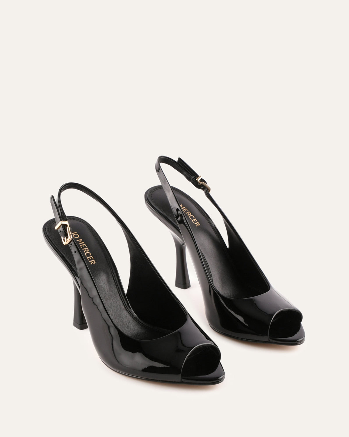 Black high-heeled open-toe shoes on a white background