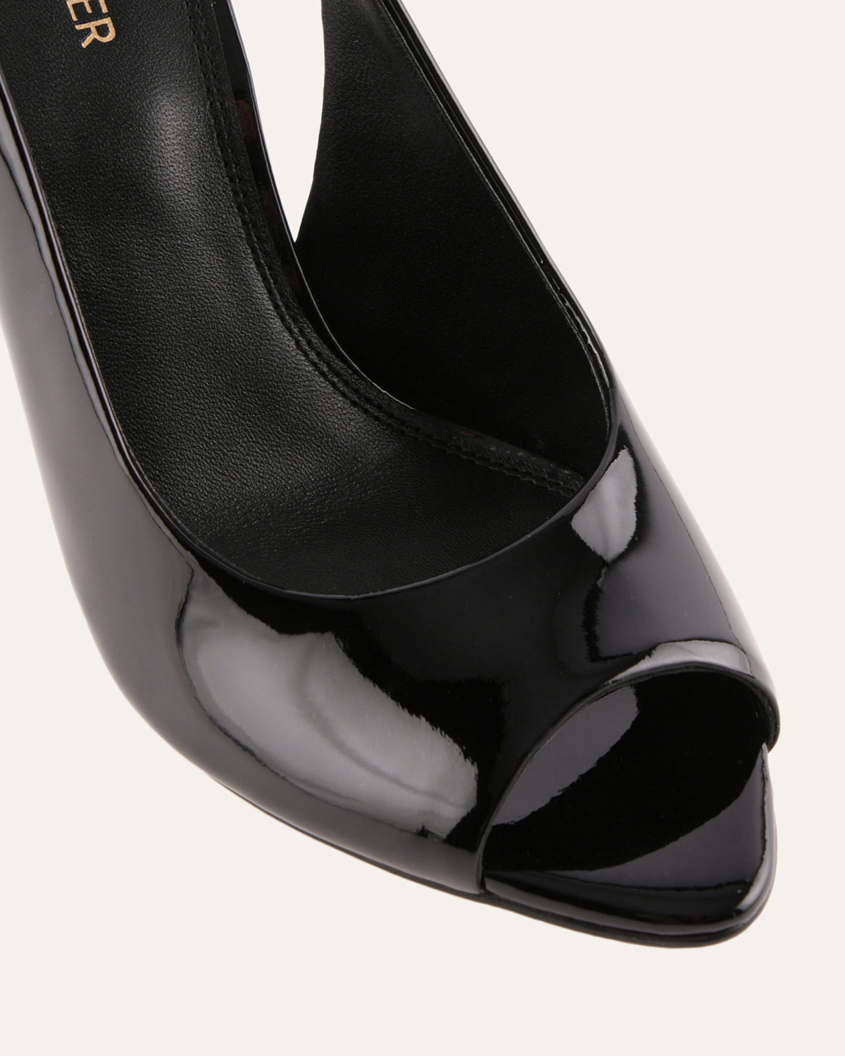 Black high-heeled shoe with peep-toe design on a white background