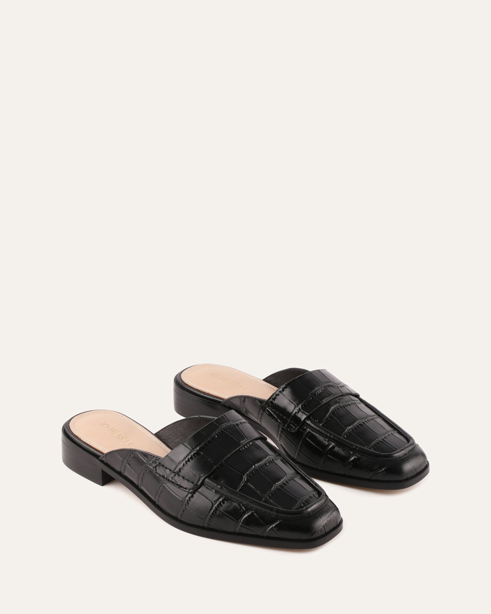 Black crocodile-patterned loafer on a white background