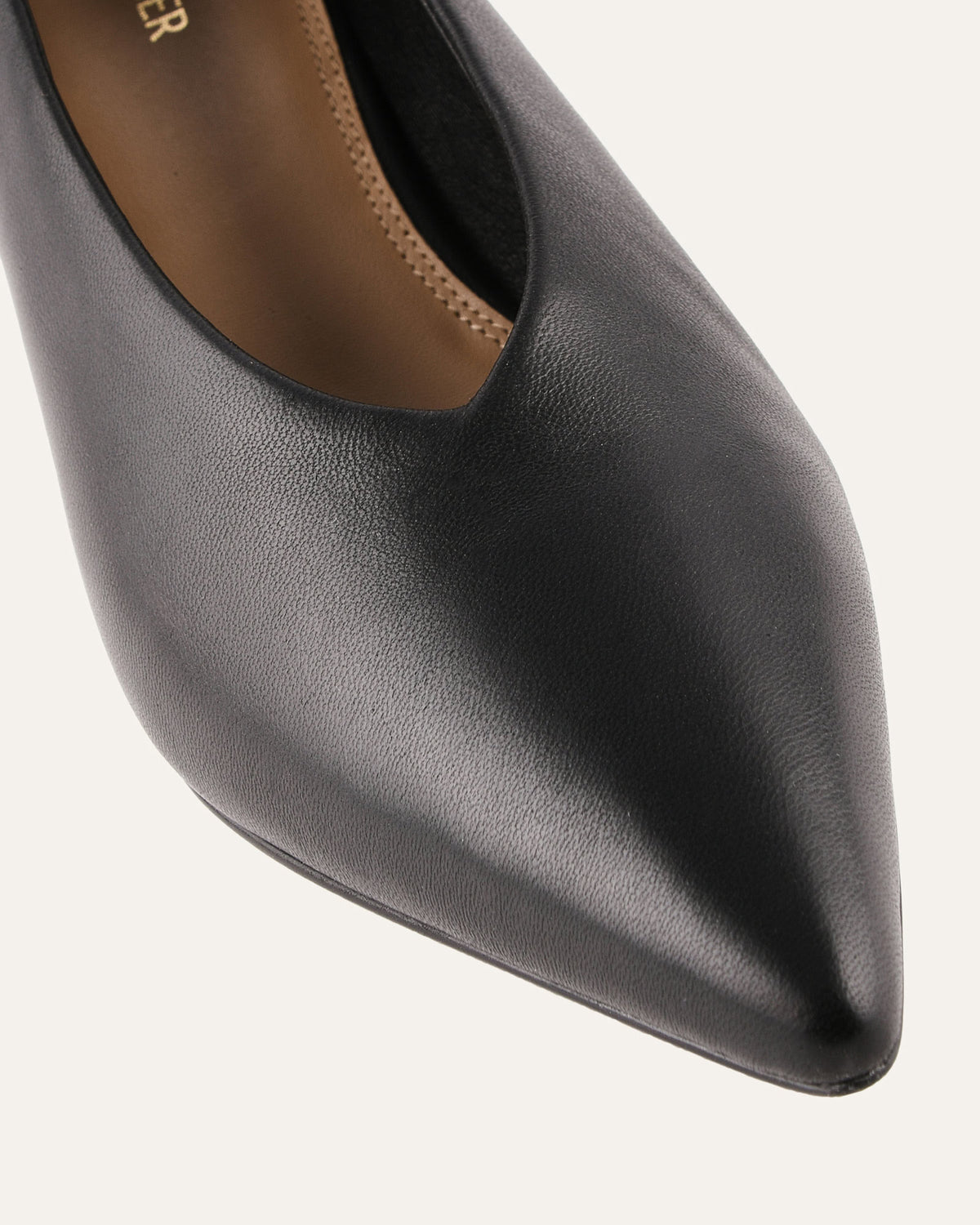 Black pointed-toe shoe on a white background