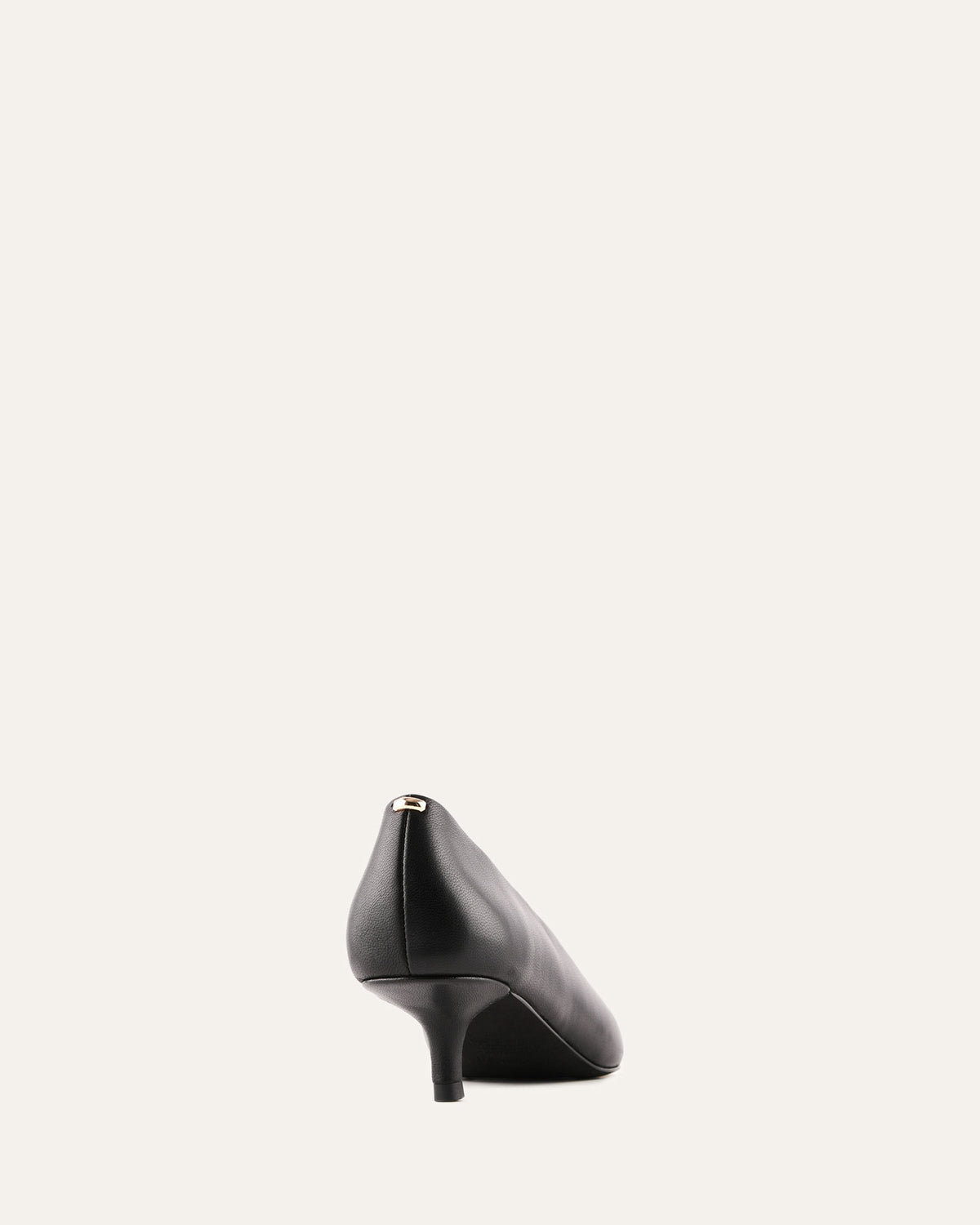 Black high-heeled shoe on a light gray background
