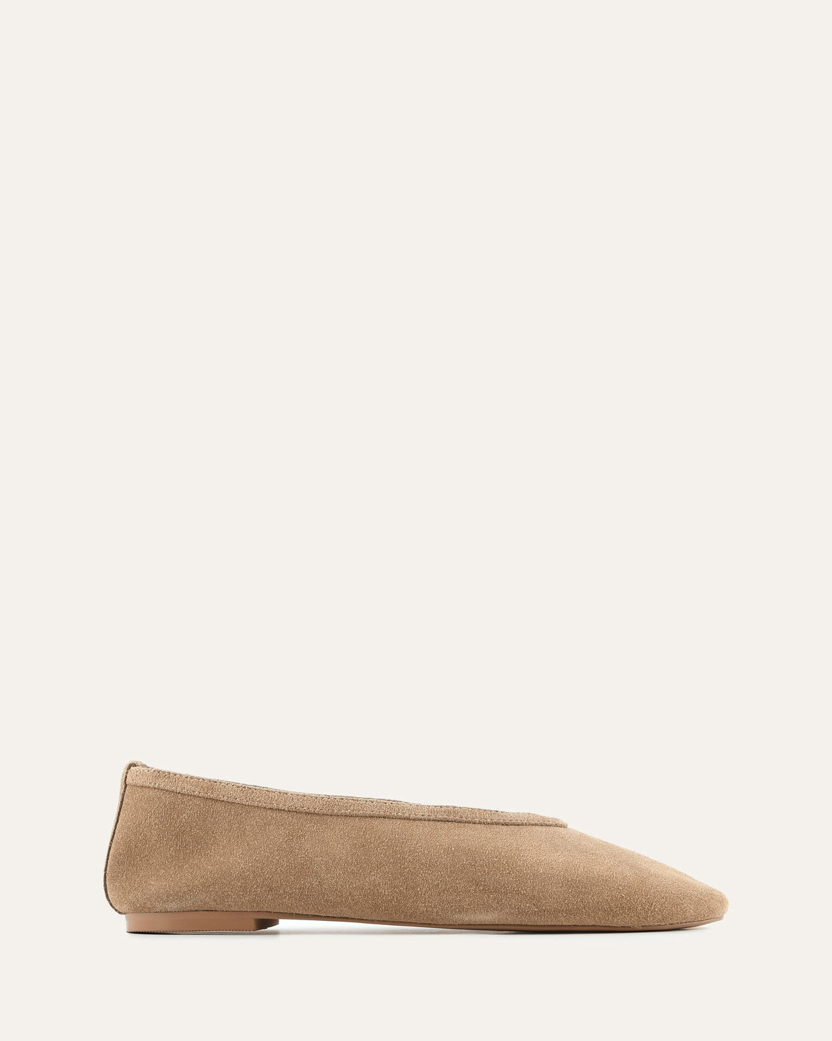 Beige flat shoe on a light beige background