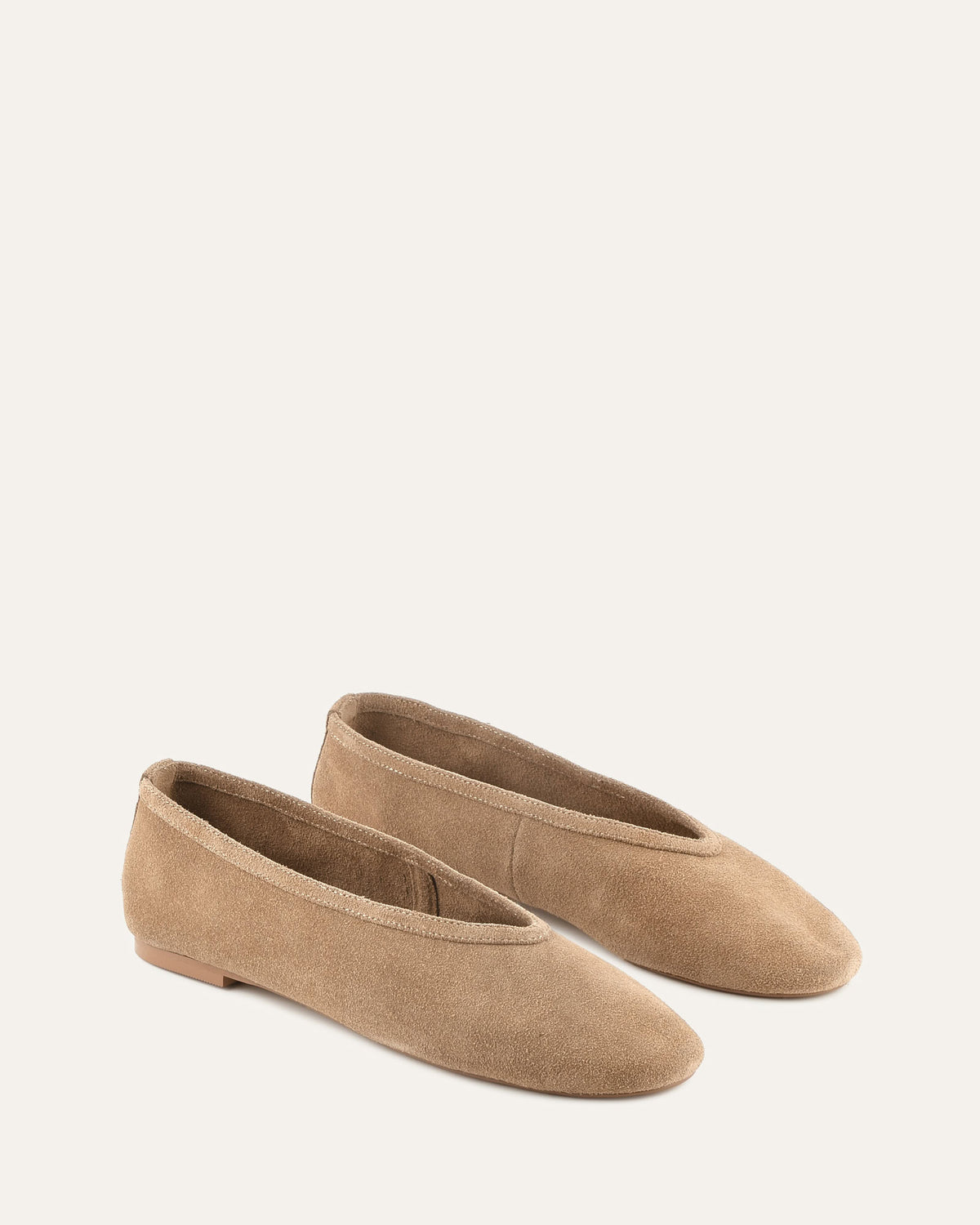Pair of brown suede shoes on a white background