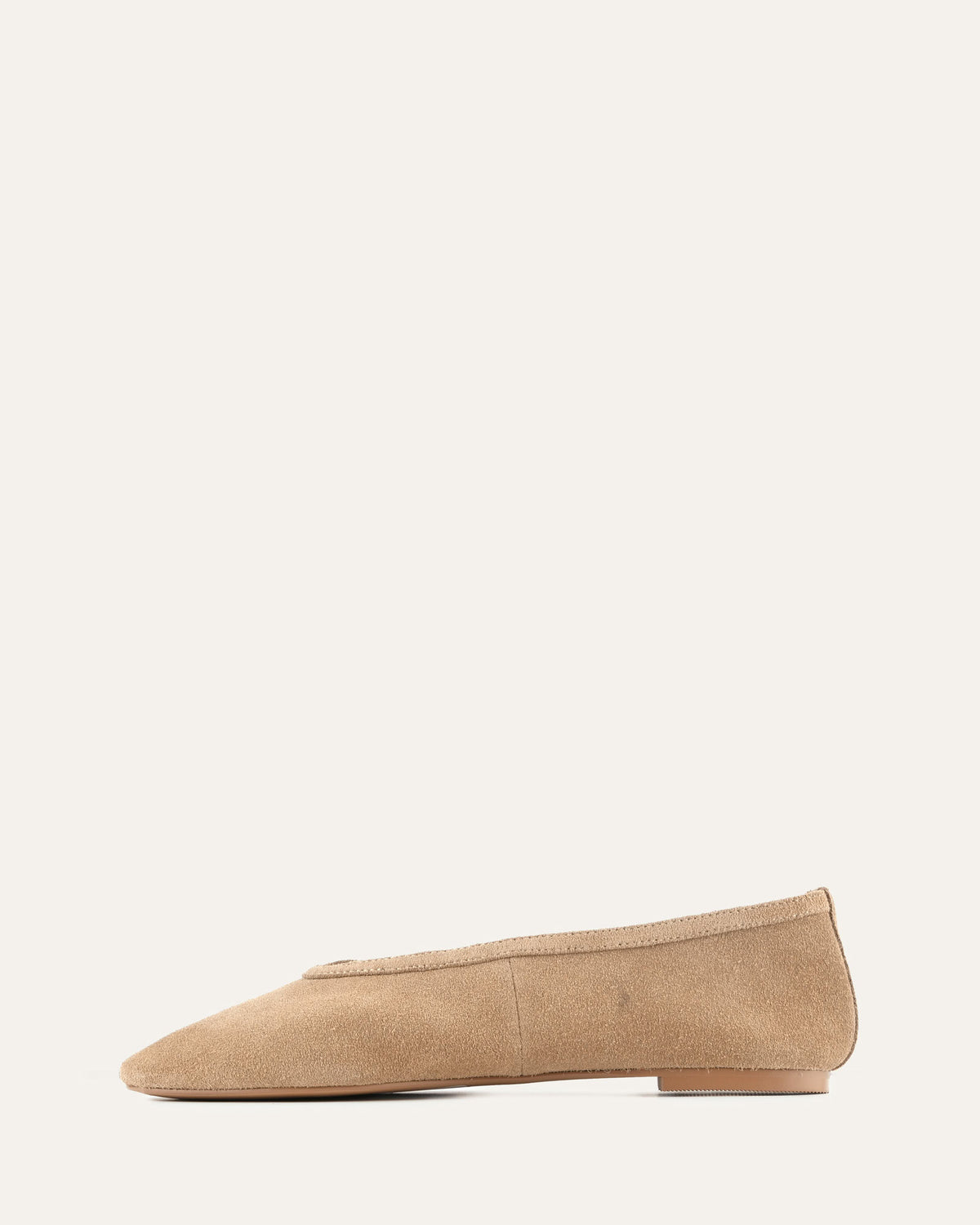 Beige flat shoe on a white background
