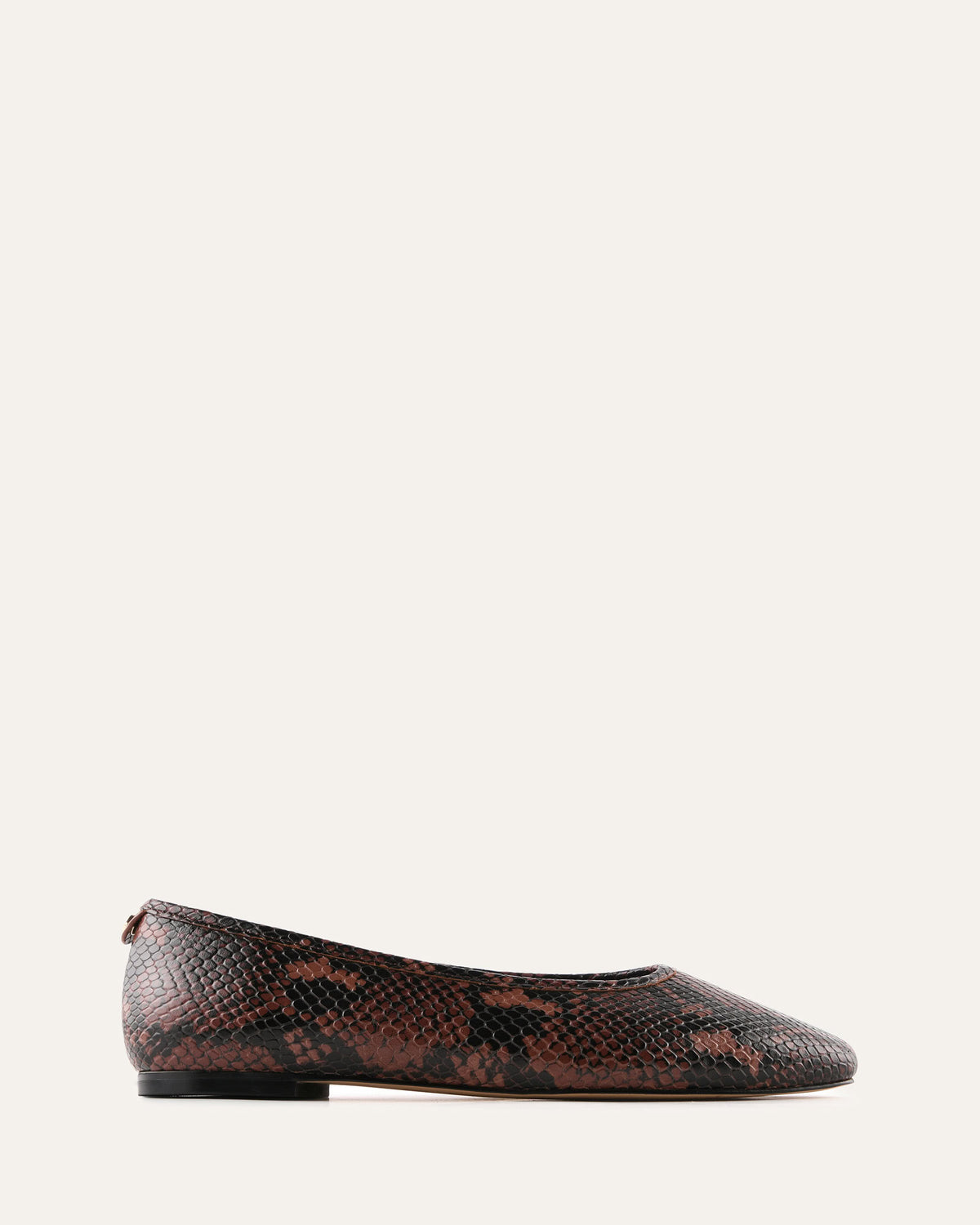 Brown snake skin patterned flat shoe on a white background