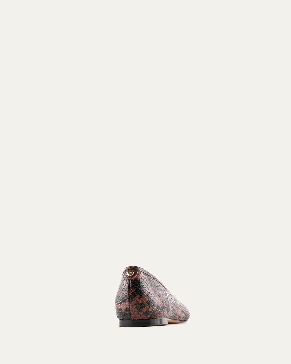 Snake patterned shoe on a light beige background