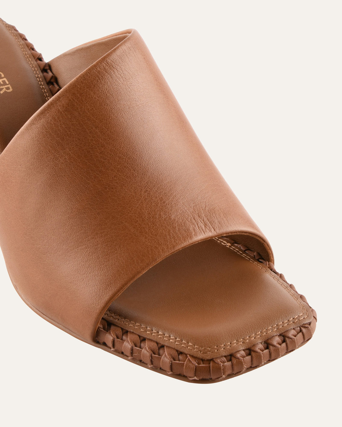 Brown leather sandal with open toe on a white background