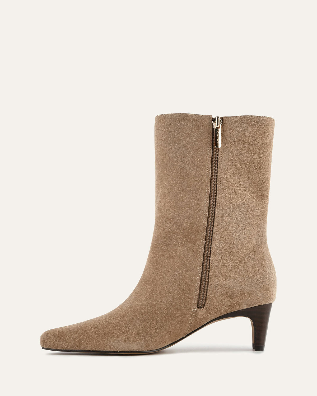 Beige ankle boot with a zipper on a light beige background