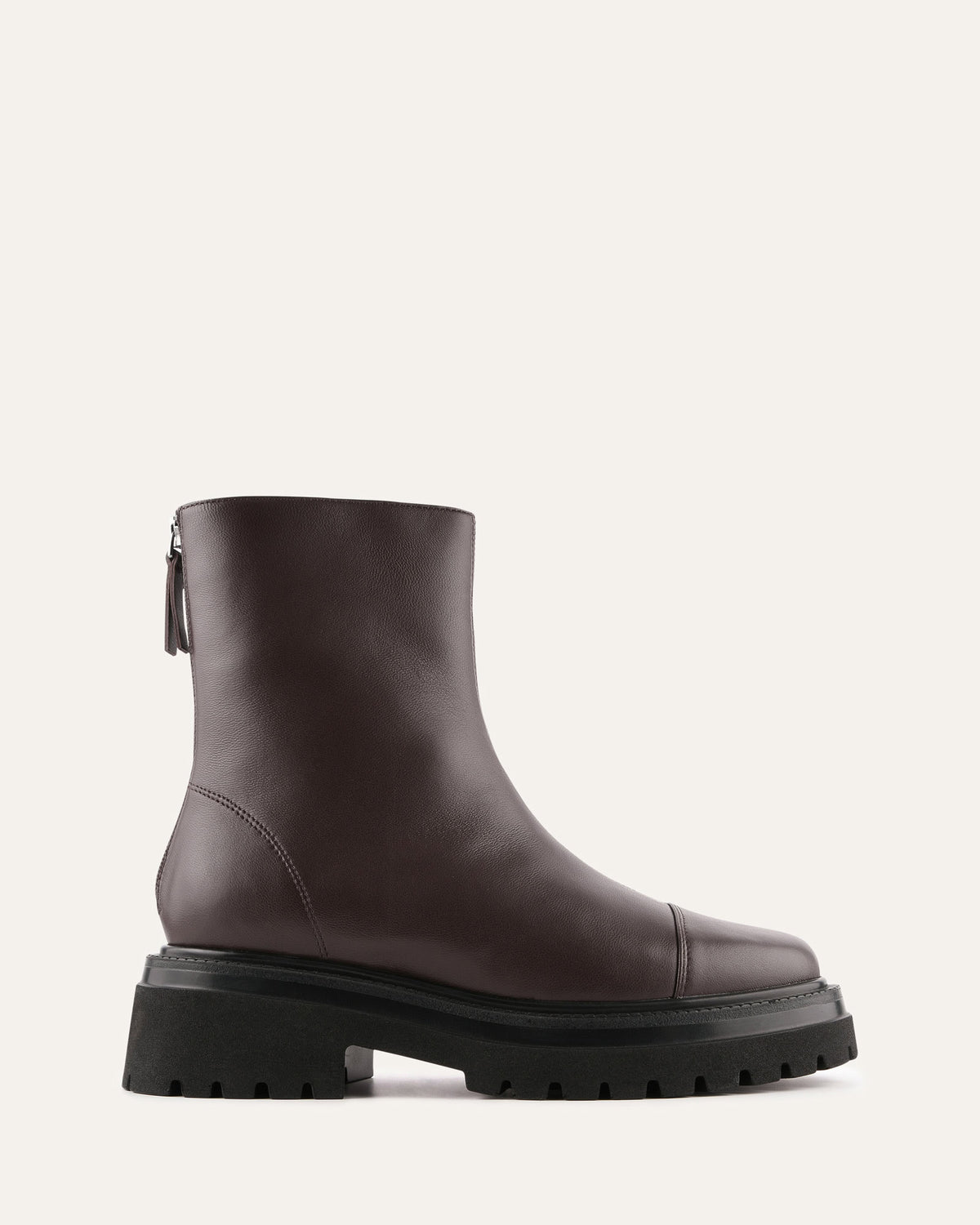 Brown leather boot with a thick sole on a light gray background