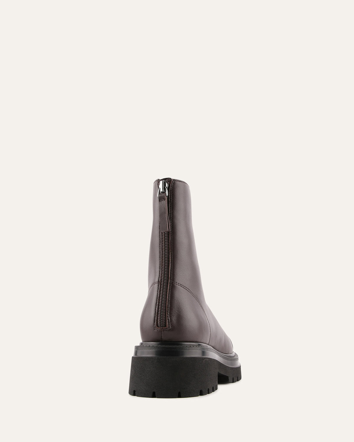 Dark gray leather boot with a black sole on a light gray background