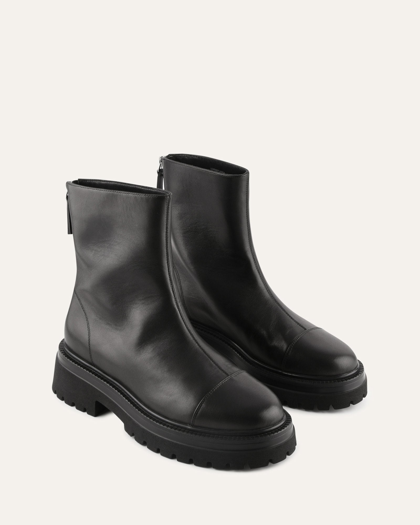 Black ankle boot on a light gray background