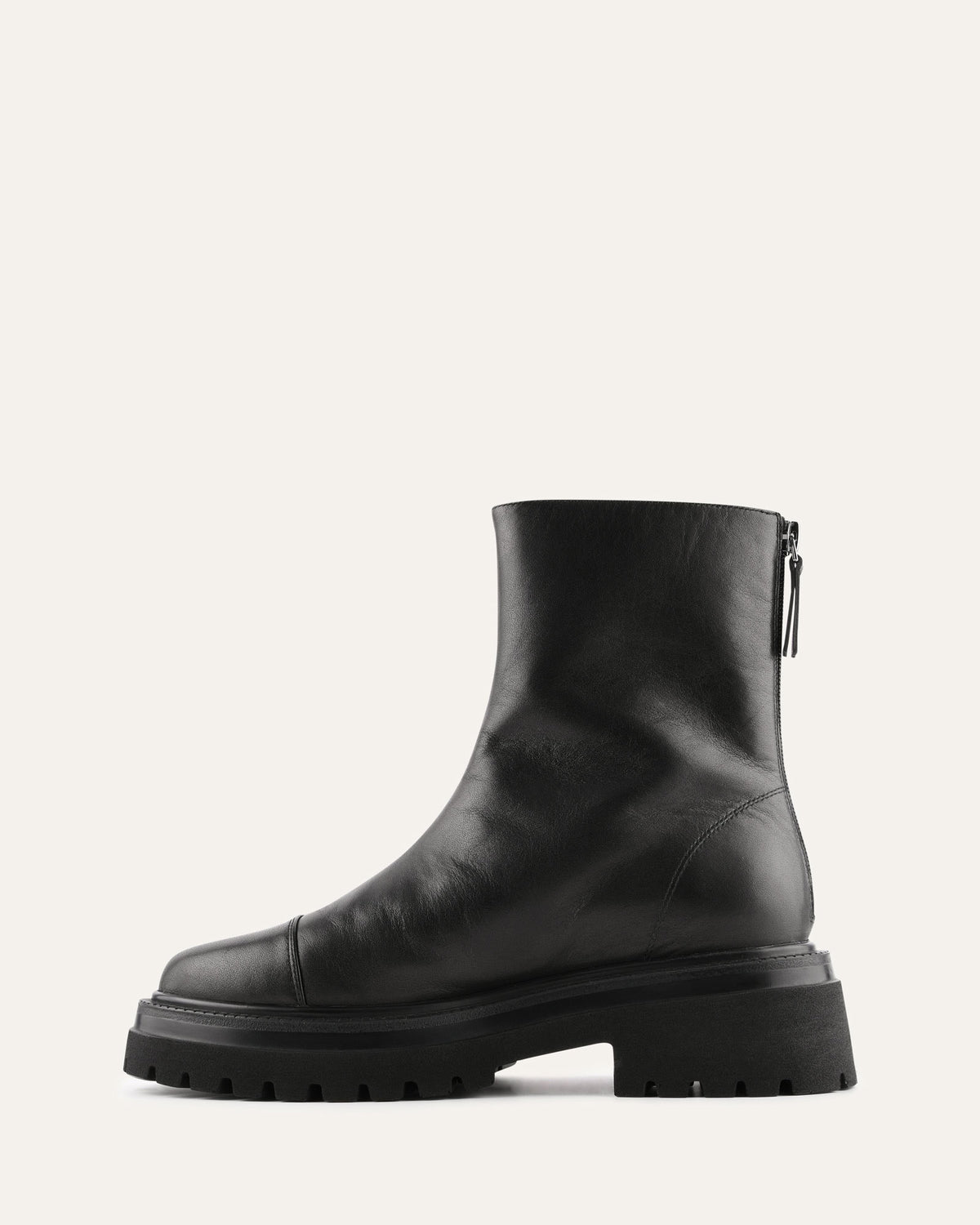 Black leather boot with a zipper on a light gray background