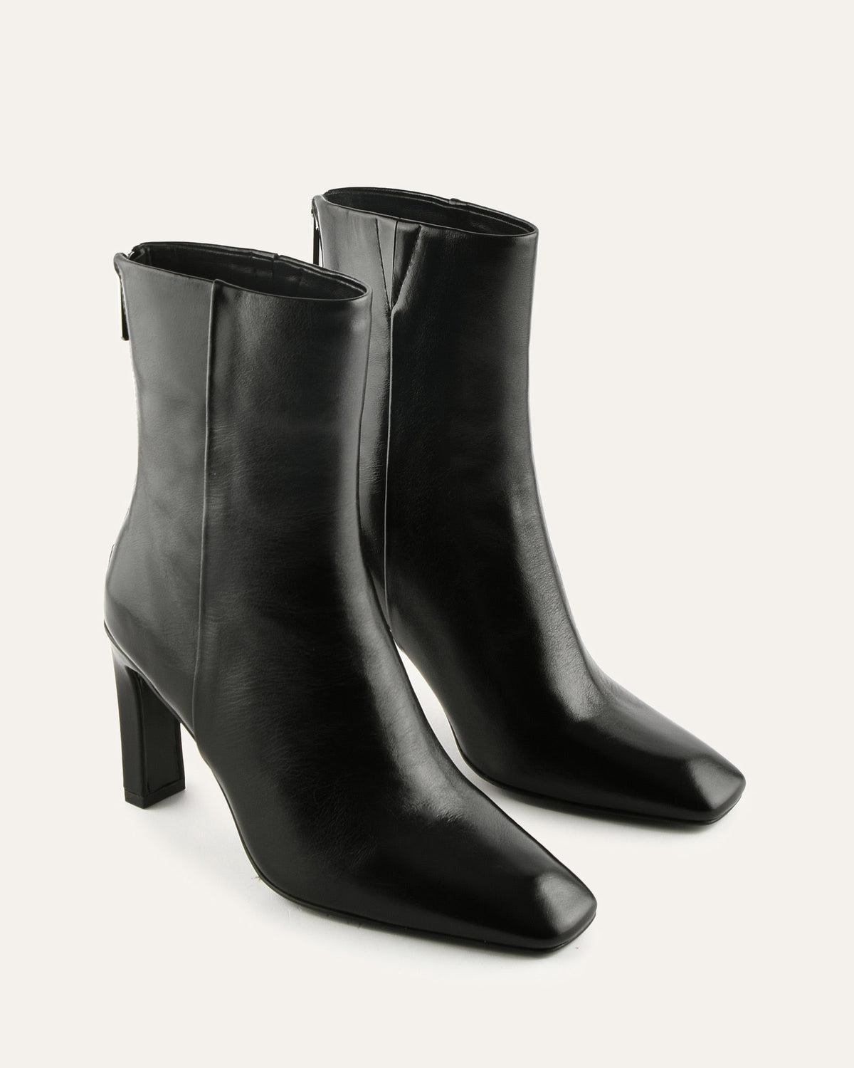 Pair of black ankle boots on a white background