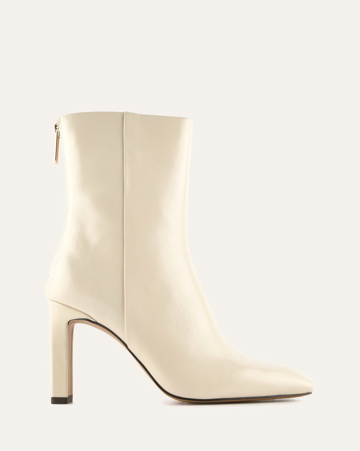 White ankle boot with a high heel on a light gray background