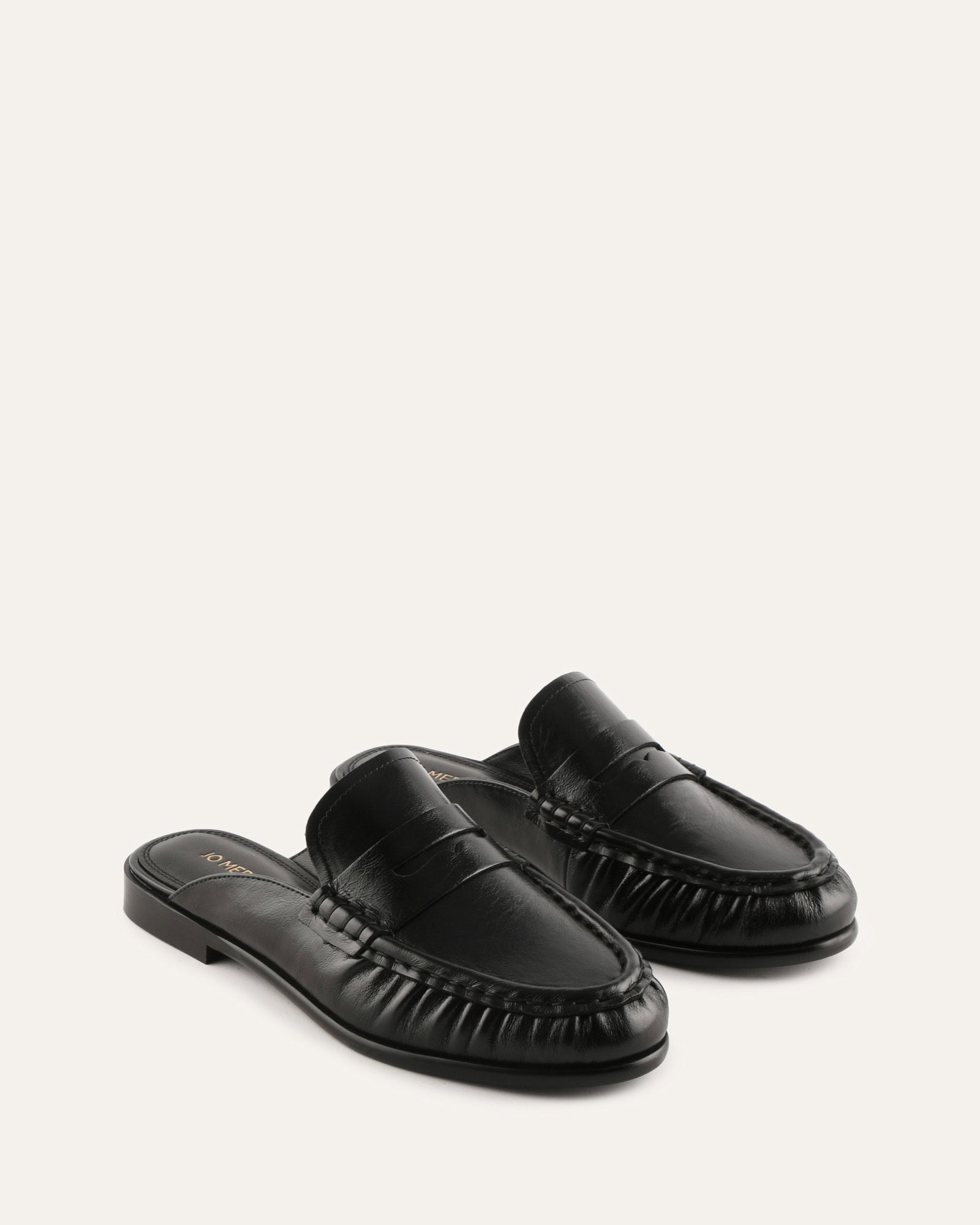 Black loafer shoe on a light gray background