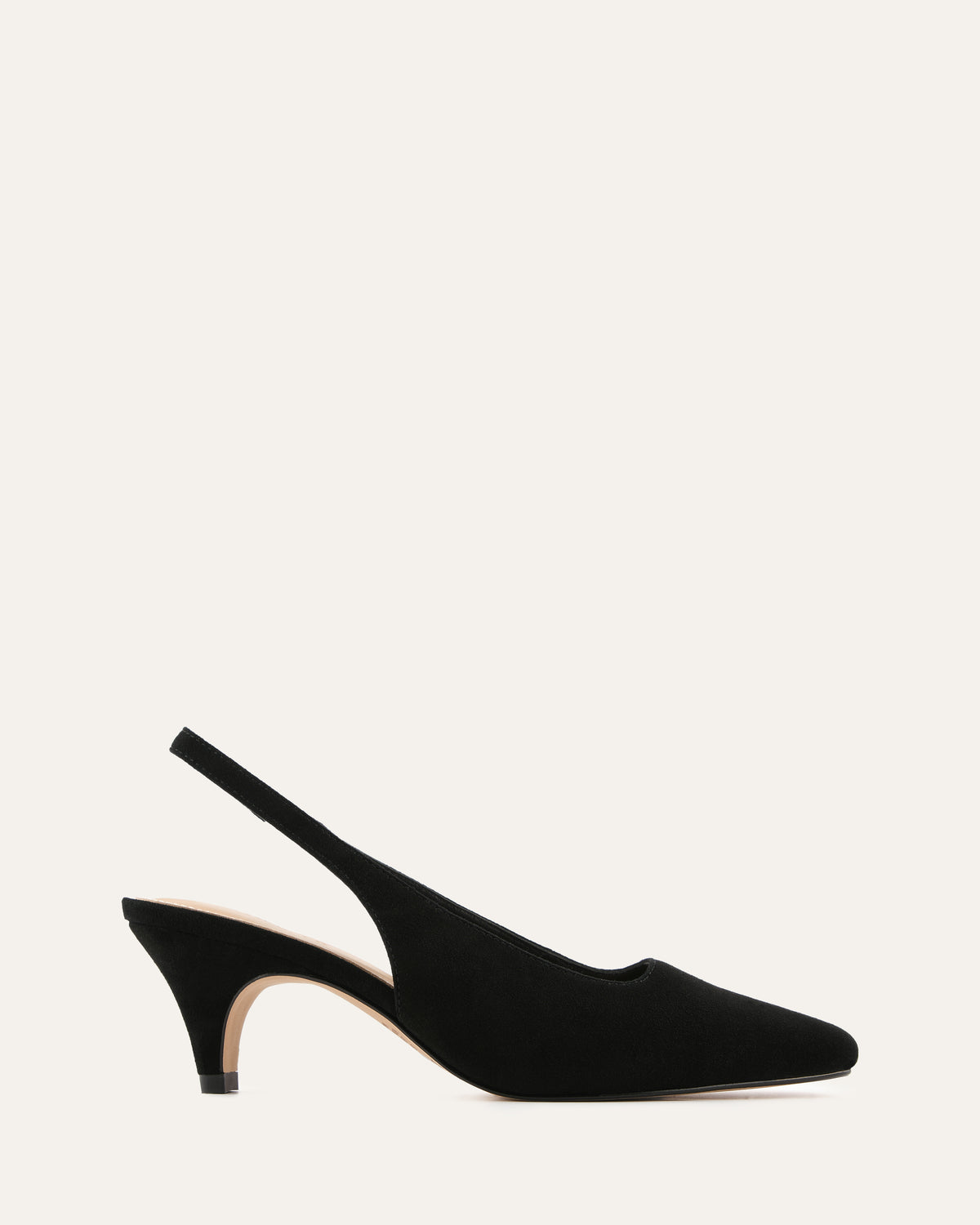 Black slingback heels on a light beige background