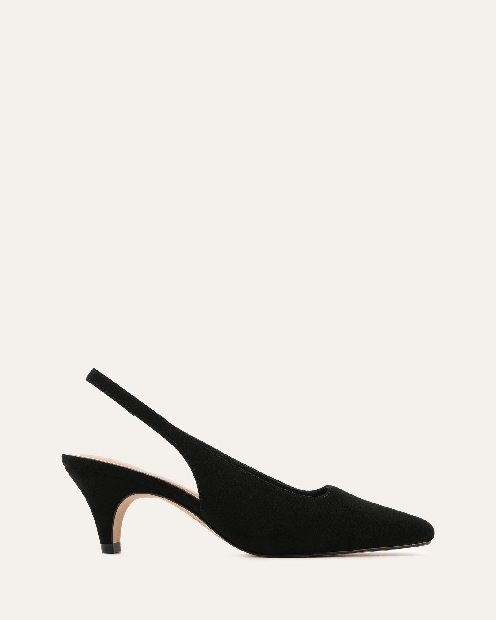 Black slingback heels on a light beige background