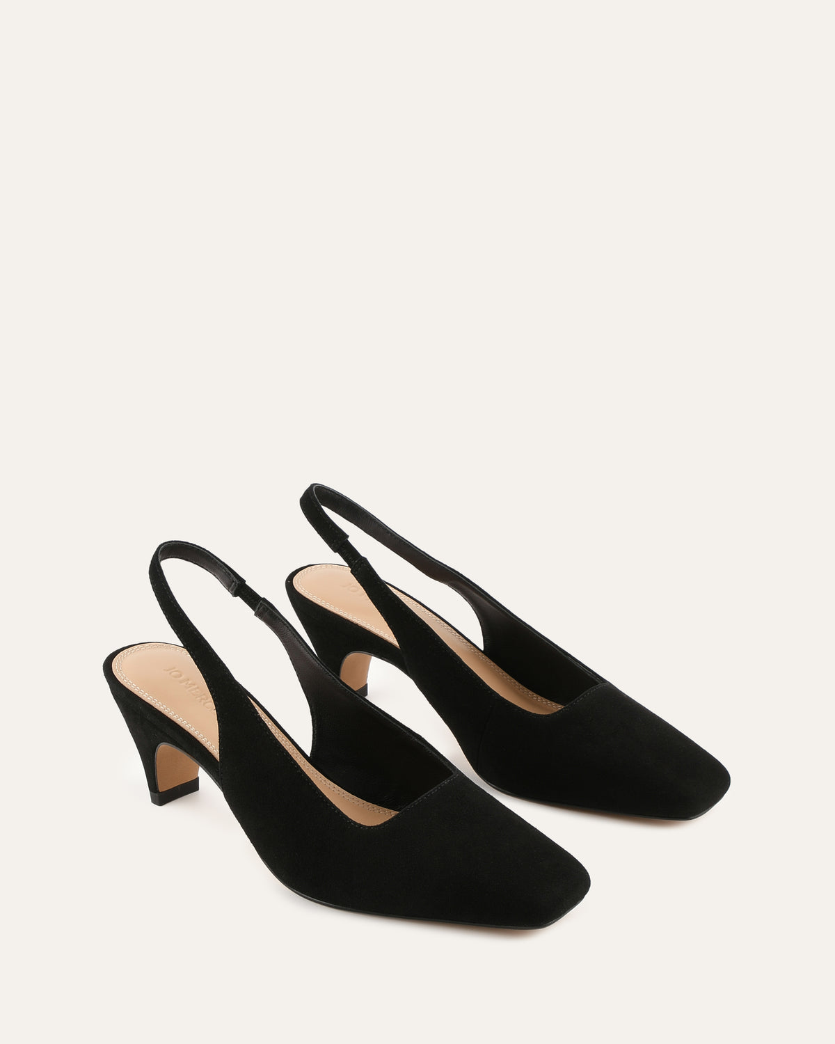 Black slingback heels on a light gray background