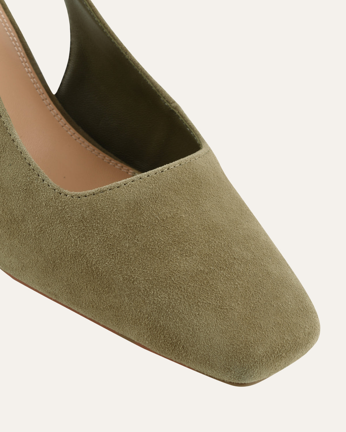 Green suede flat shoe on a white background