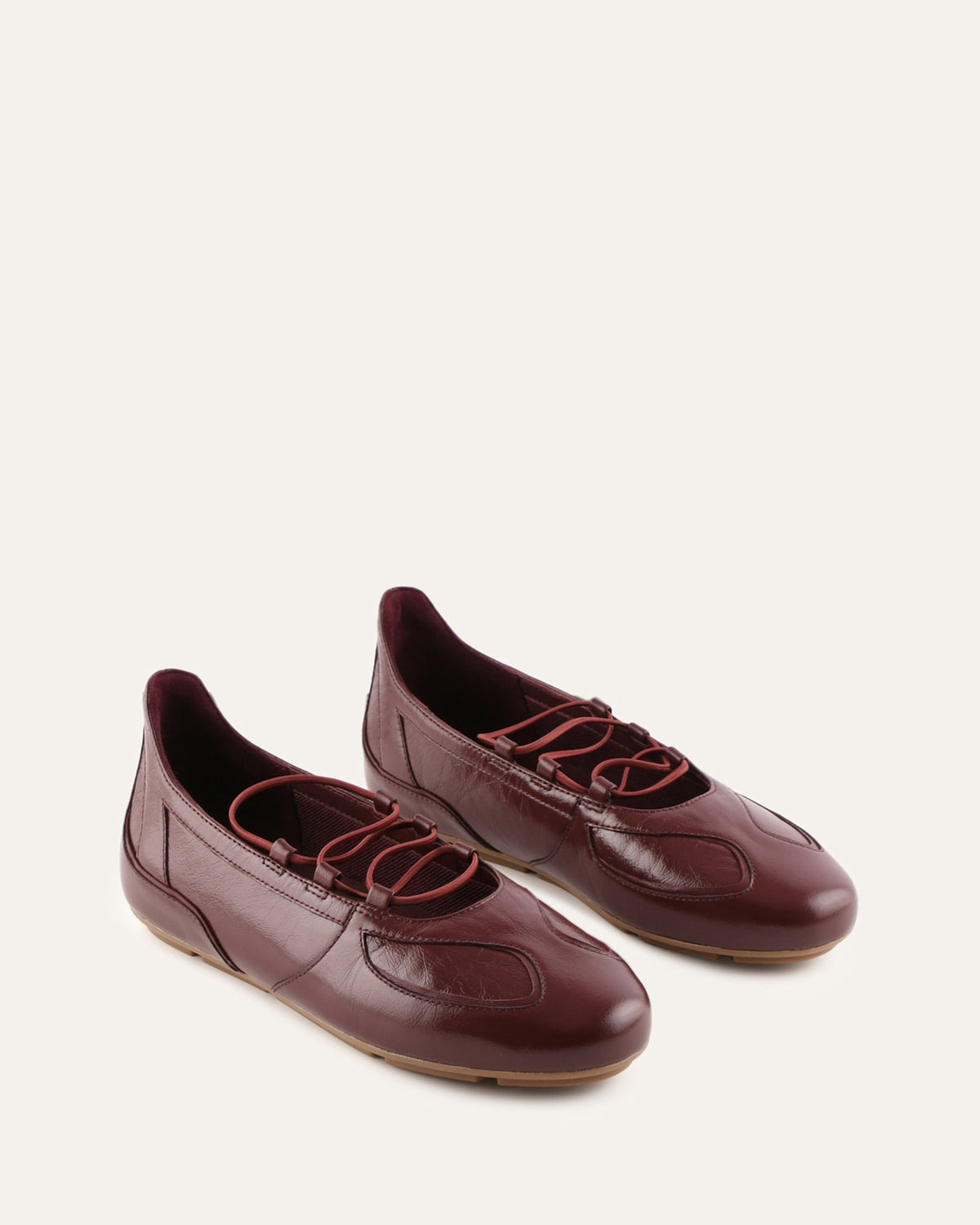 Pair of maroon leather shoes on a white background