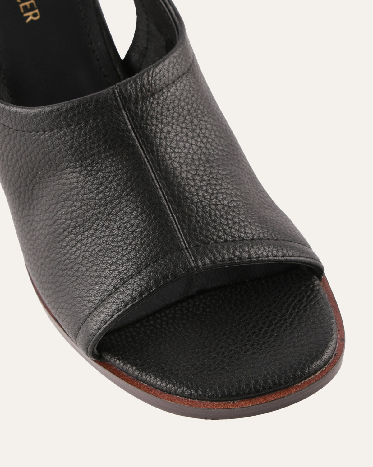 Black open-toe sandal on a white background