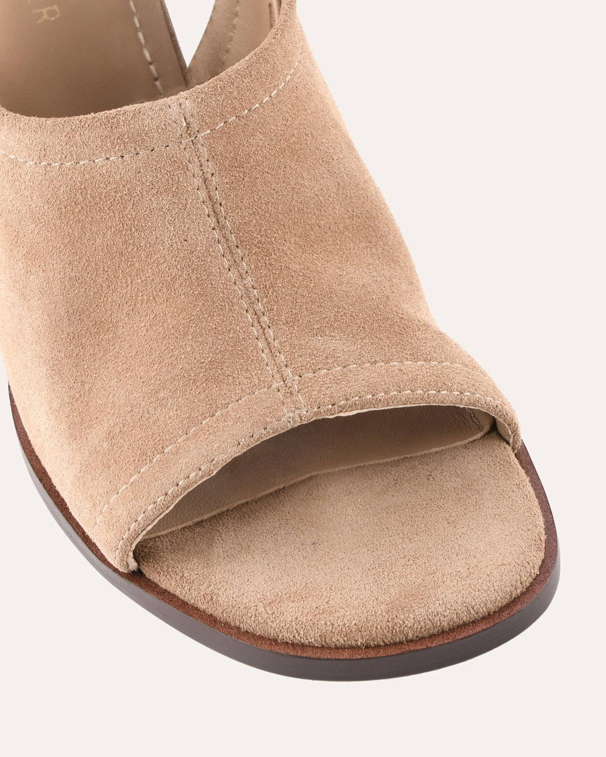 Beige open-toe sandal on a white background