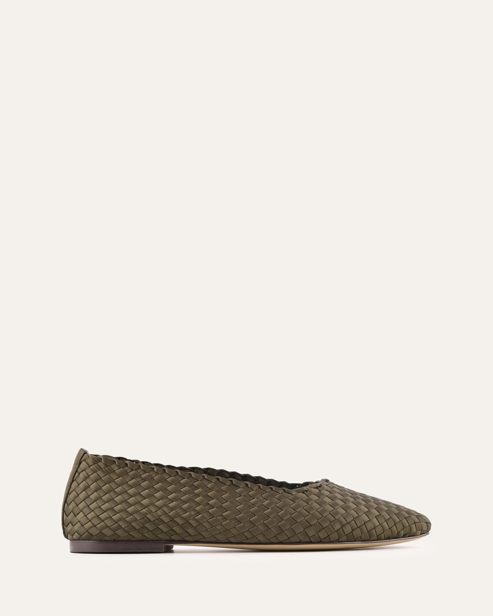 Green woven flat shoe on a white background