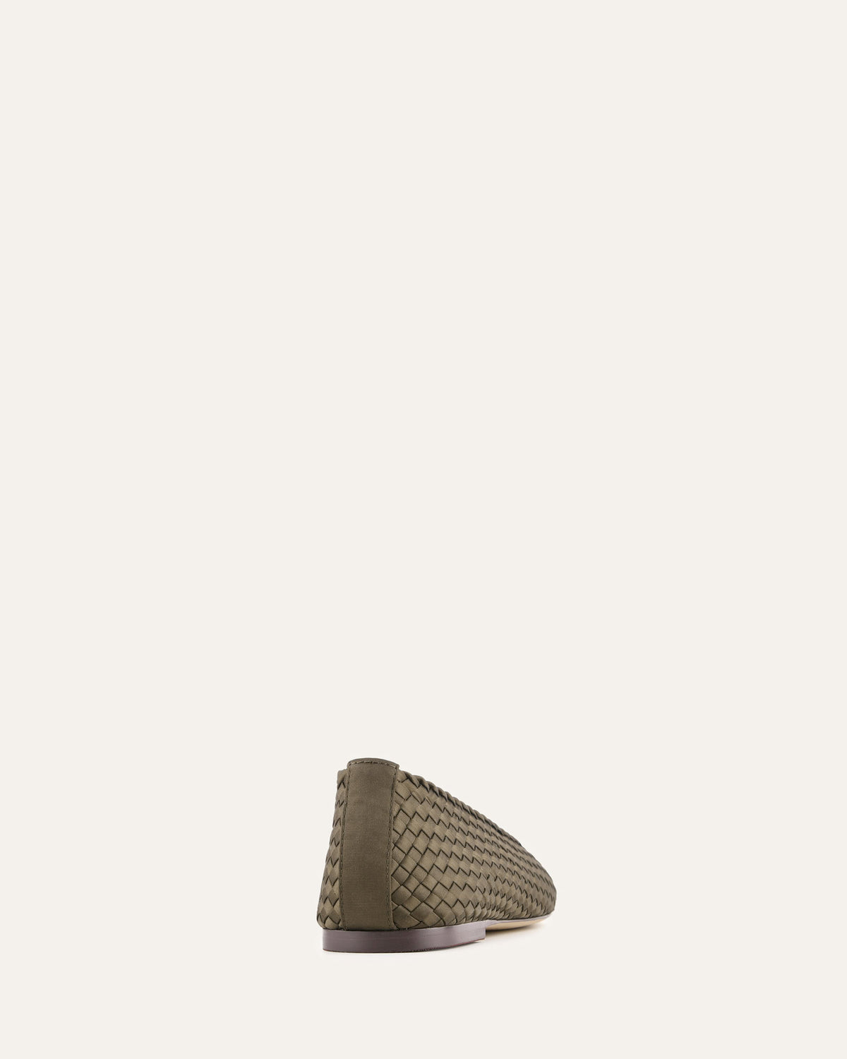 Green woven flat shoe on a white background