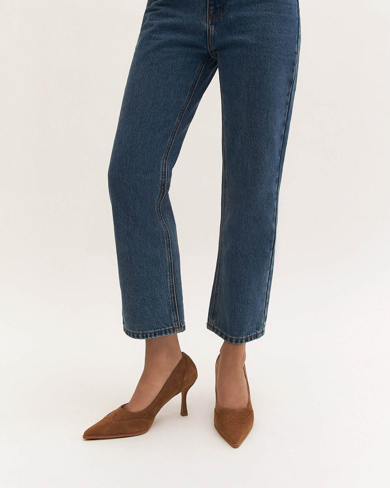 Brown suede high heel shoe on a white background