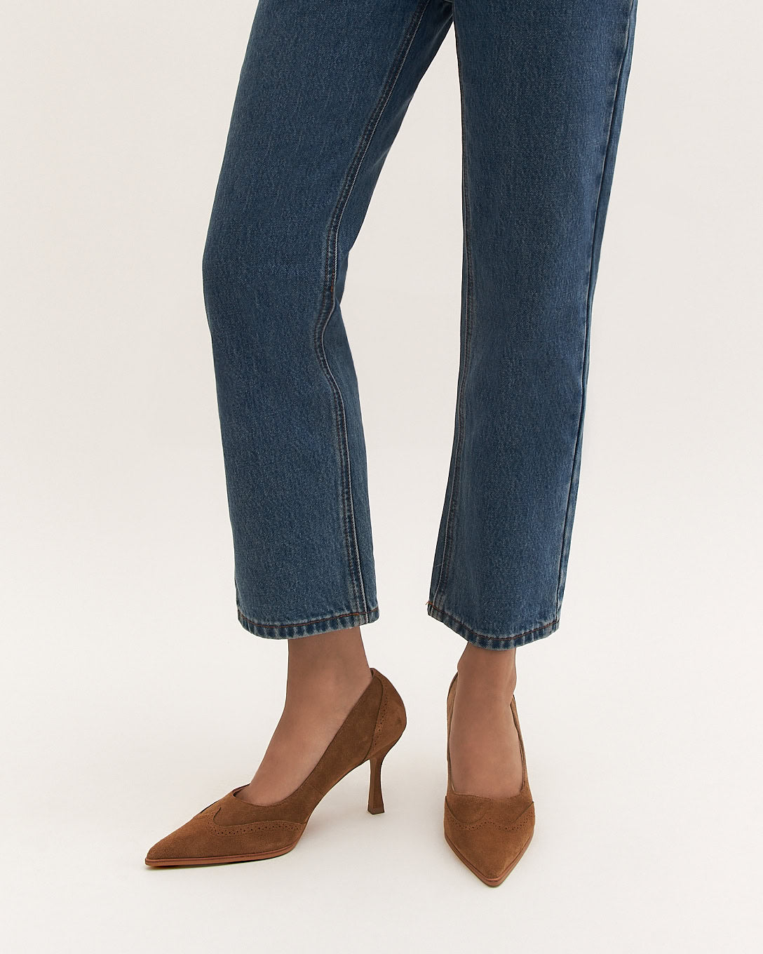 Brown suede high heel shoe on a white background