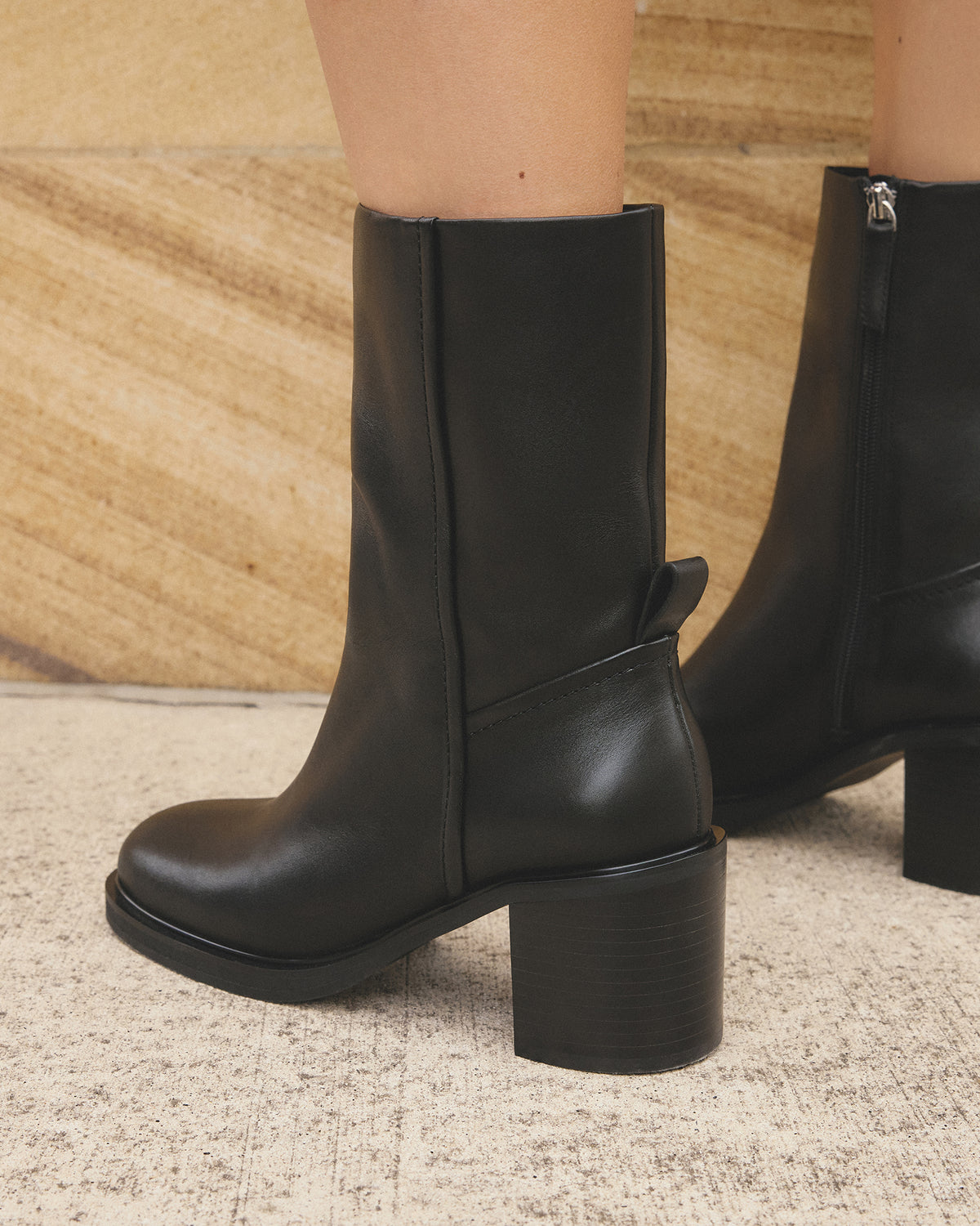 Black leather boots on a neutral background