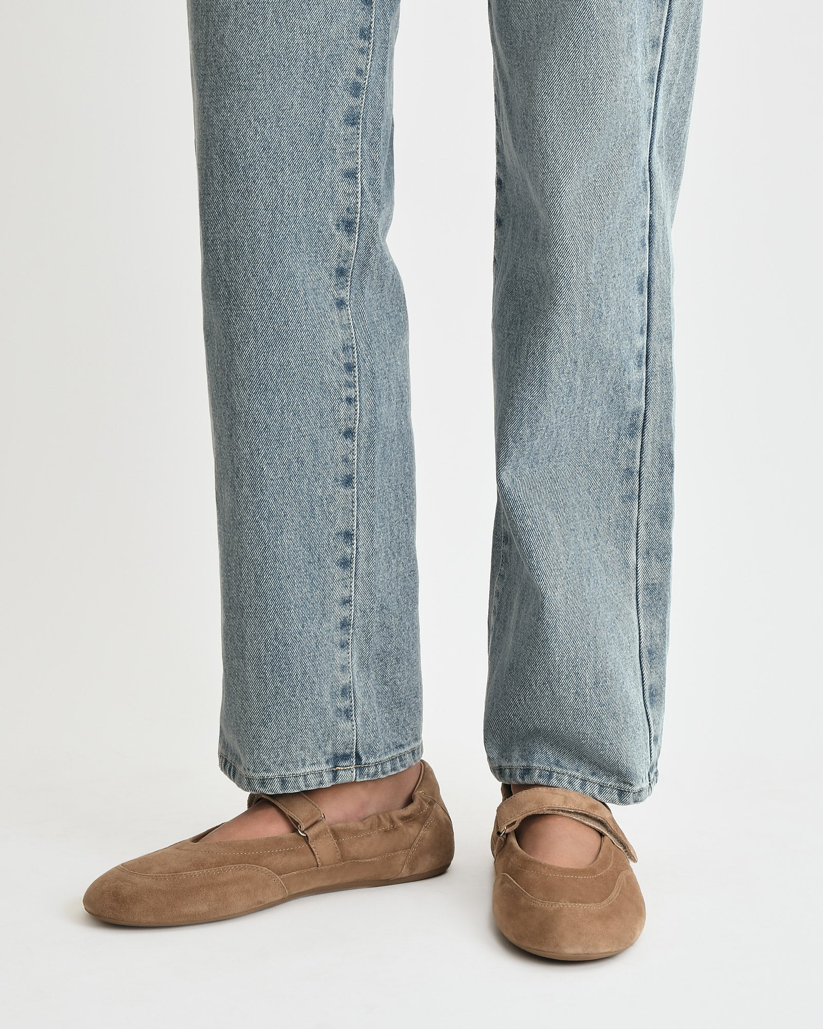 Brown suede flat shoe on a white background