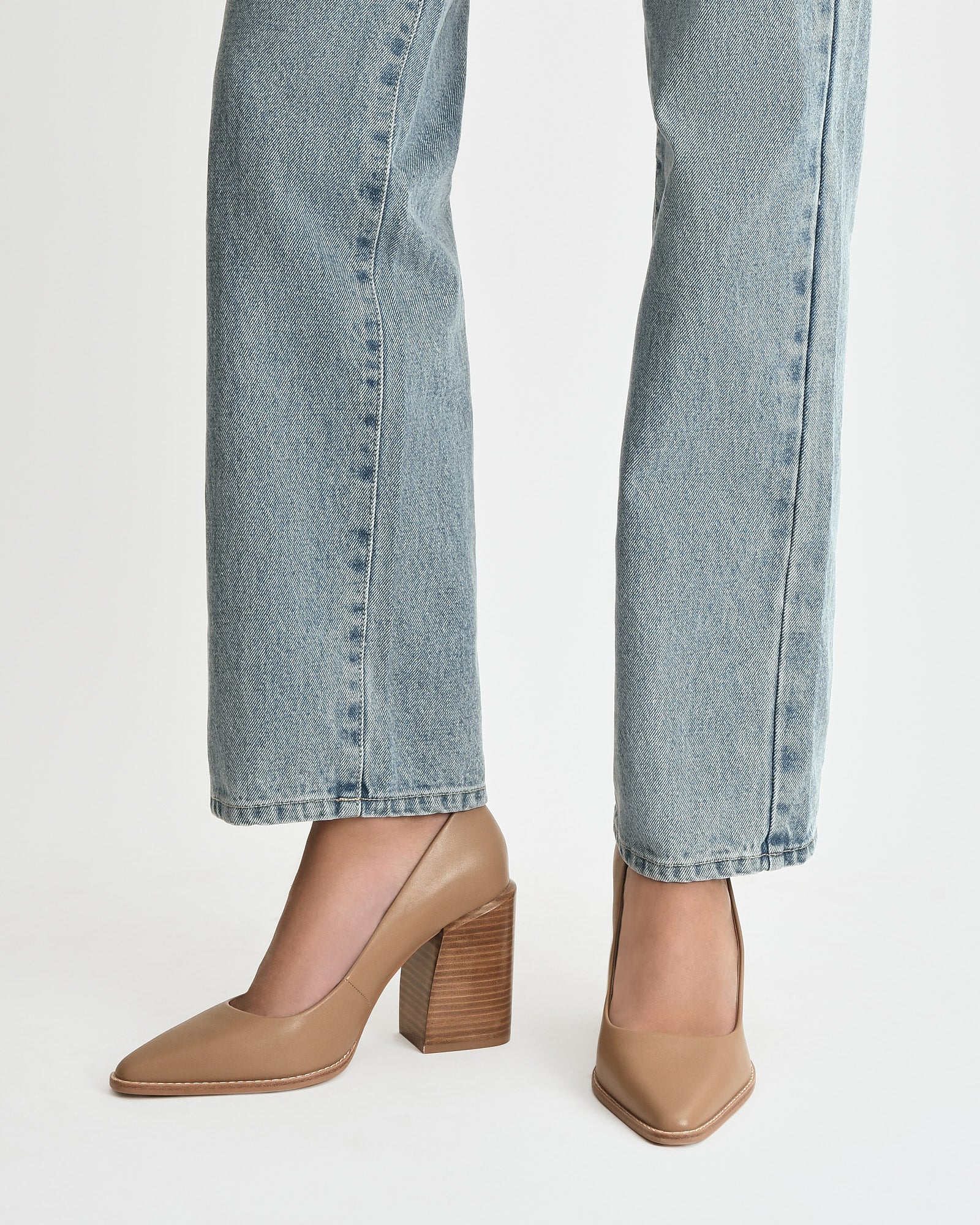 Tan high-heeled shoe on a light beige background